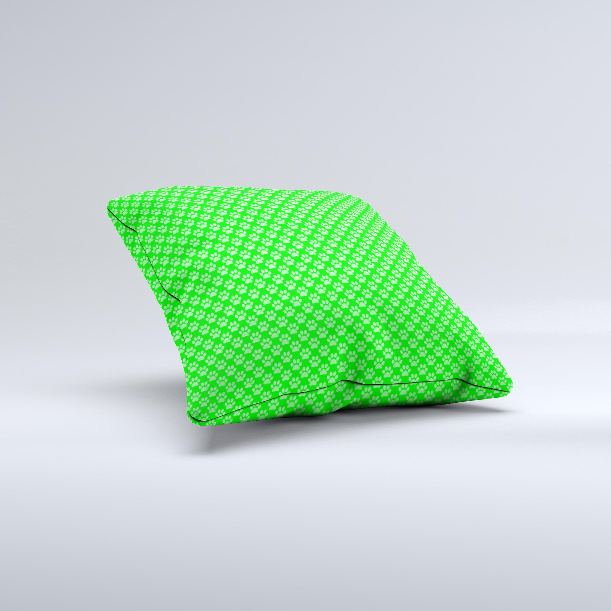 A decorative throw pillow featuring subtle green paw prints on a soft fabric, handcrafted in Virginia, showcasing unique design and quality.