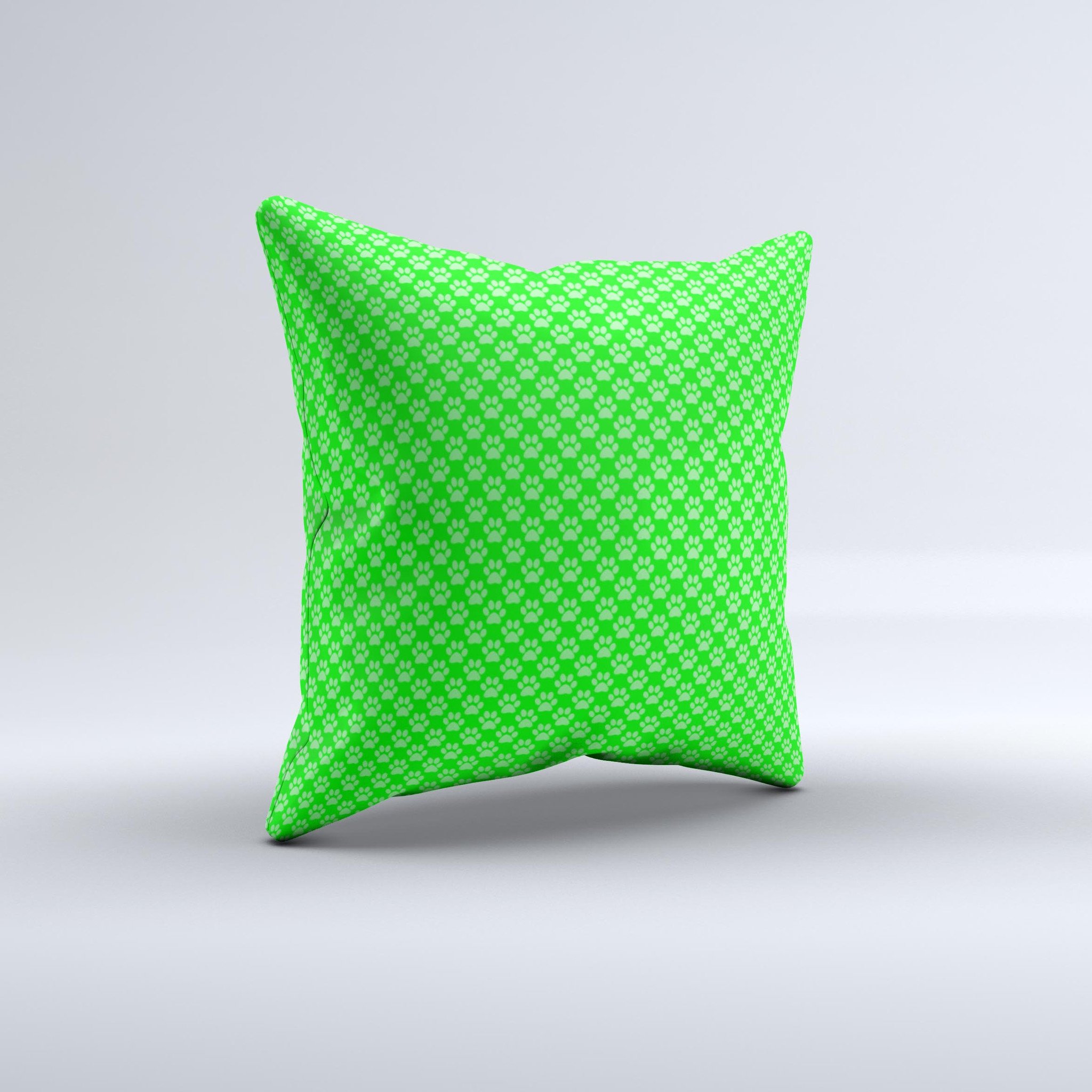 A decorative throw pillow featuring subtle green paw prints on a soft fabric, handcrafted in Virginia, showcasing unique design and quality.