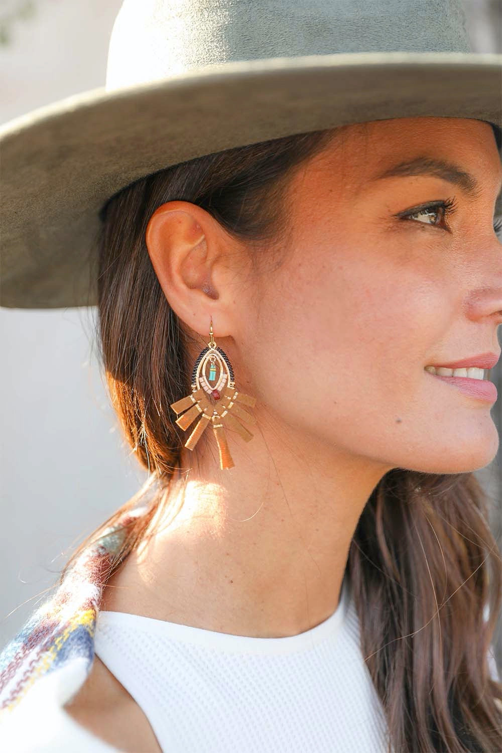 A pair of stylish suede fringe beaded earrings featuring colorful beads and a playful design, perfect for any outfit.