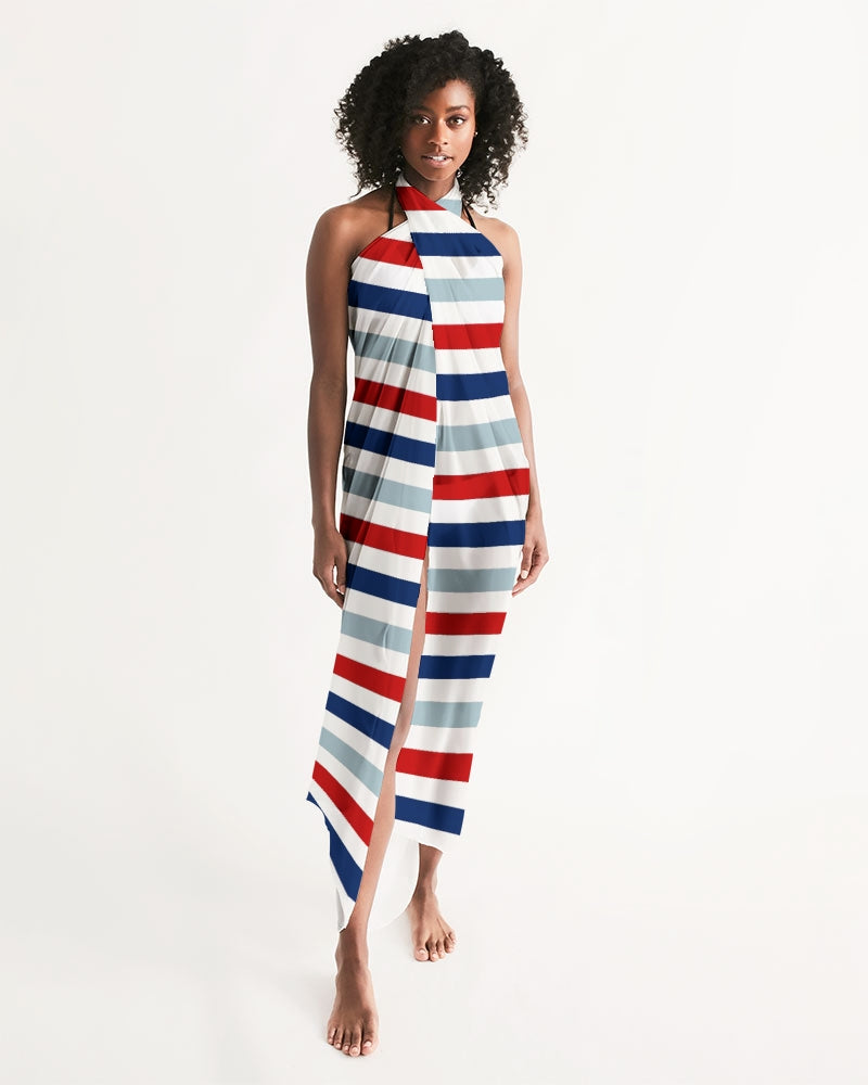 A vibrant red, white, and blue swim cover up draped elegantly, showcasing its lightweight and flowy fabric, perfect for summer outings.