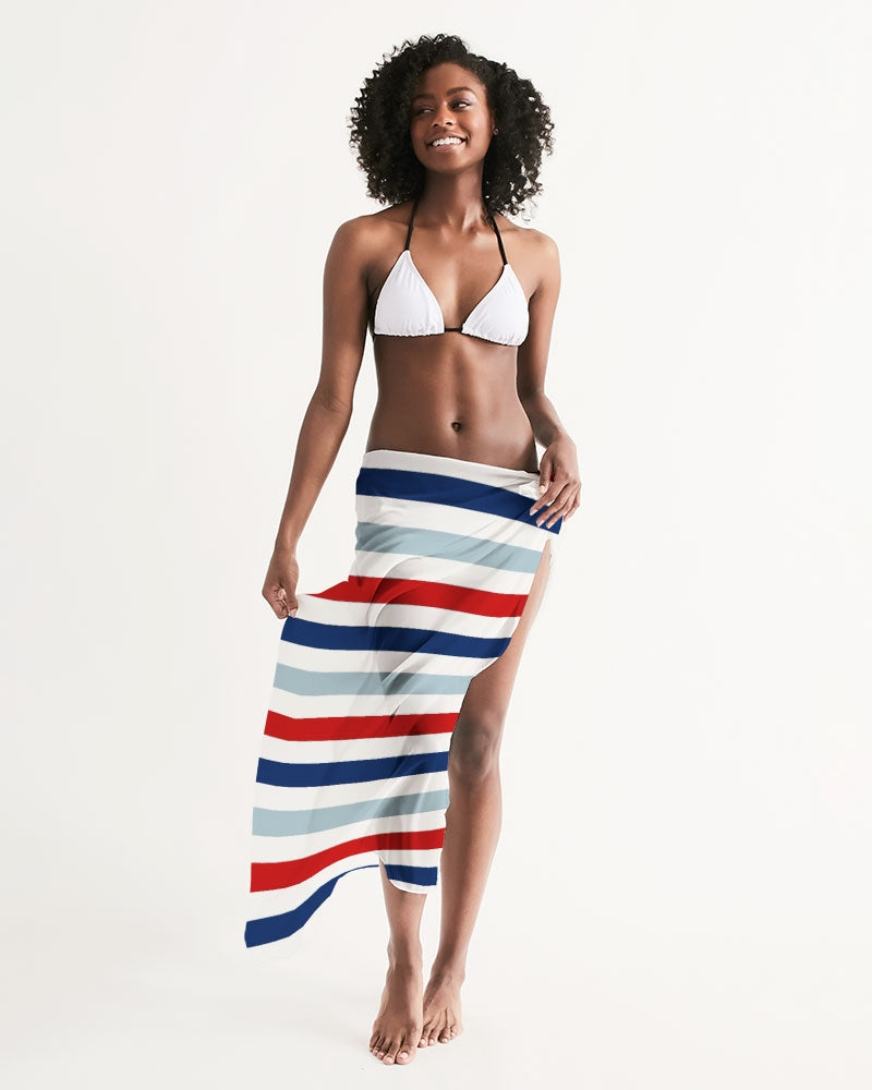 A vibrant red, white, and blue swim cover up draped elegantly, showcasing its lightweight and flowy fabric, perfect for summer outings.