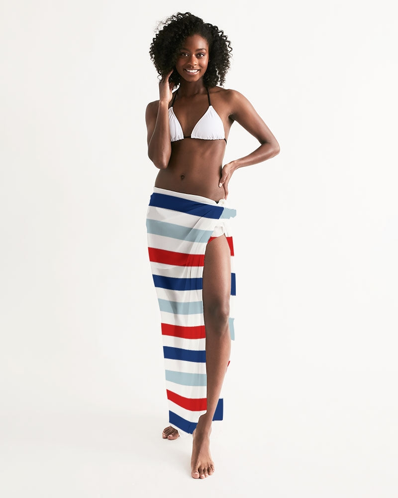 A vibrant red, white, and blue swim cover up draped elegantly, showcasing its lightweight and flowy fabric, perfect for summer outings.