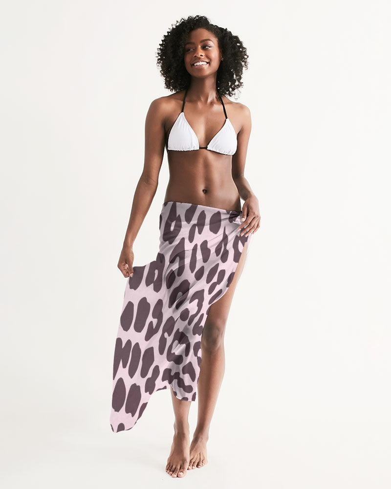 A stylish pink leopard print swim cover up draped elegantly, showcasing its lightweight and flowy fabric.