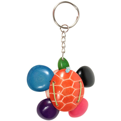 Handmade Tagua Nut Key Chain shaped like a turtle, showcasing vibrant colors and unique patterns, symbolizing eco-friendliness and artisan craftsmanship.