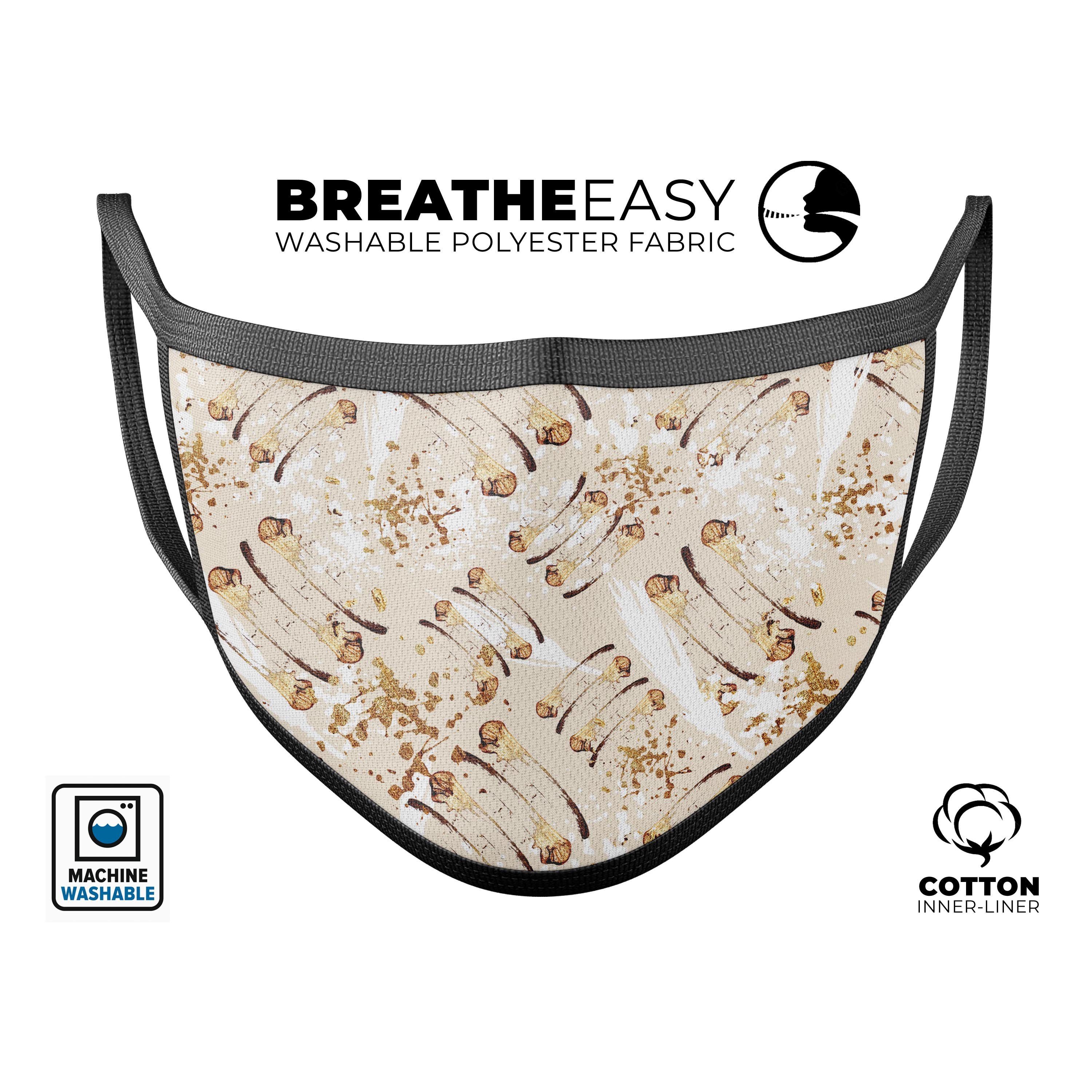 Tan Brush Strokes of Gold reusable mouth cover, featuring adjustable ear-loops and a comfortable cotton interior, made in the USA.