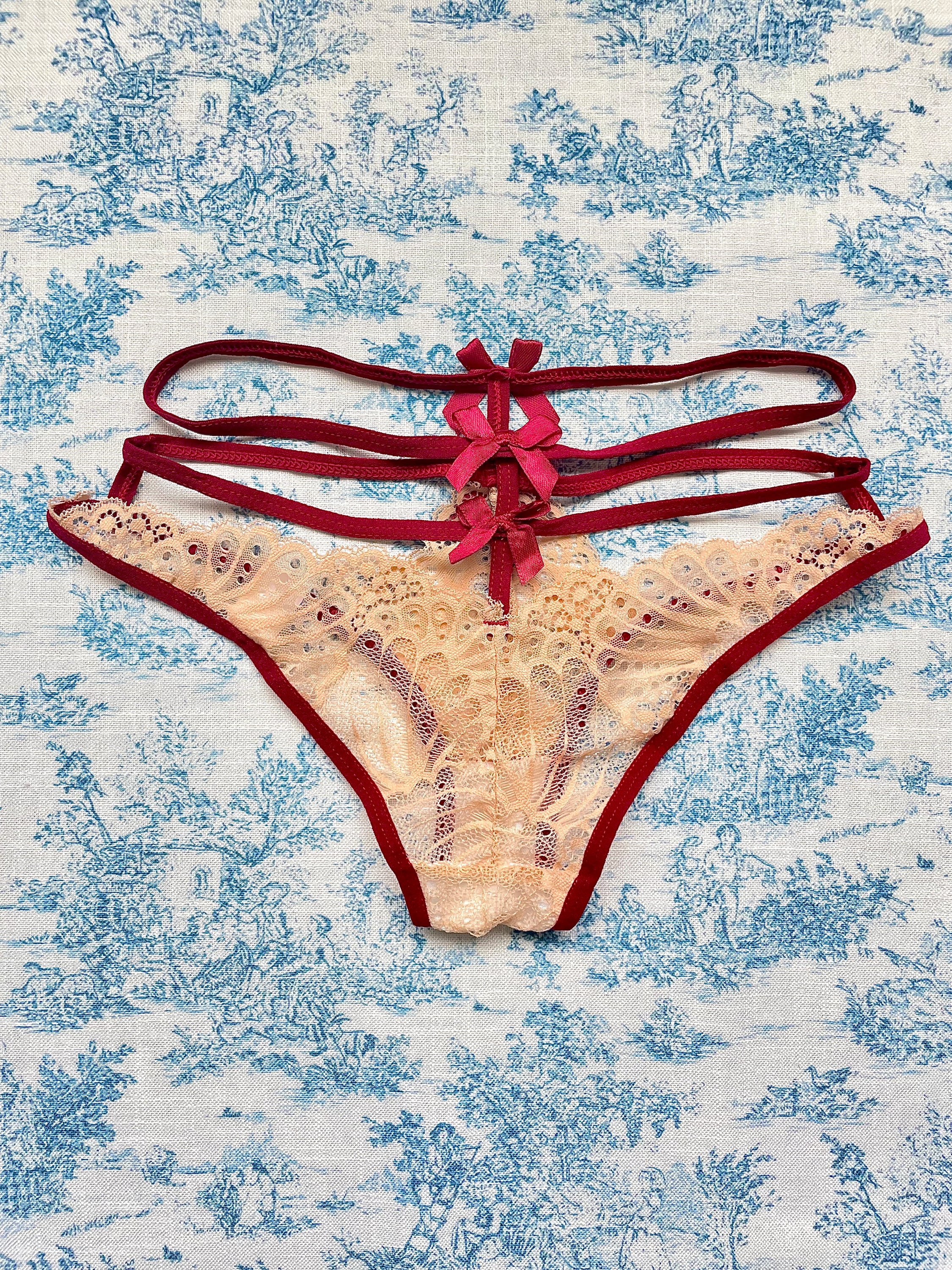 Tan and red straps bow panty featuring delicate lace and playful bow details, designed for comfort and style.