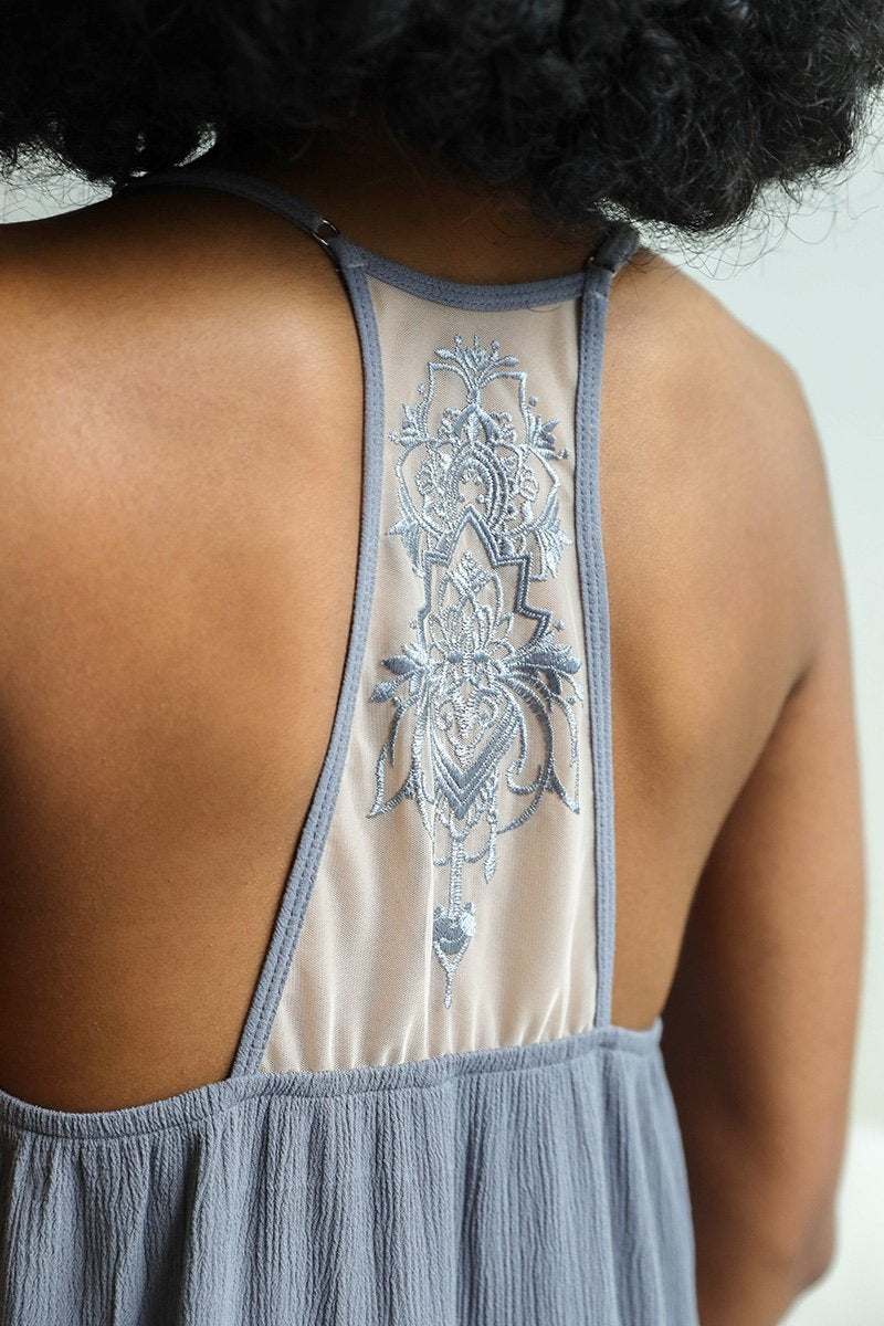 Tattoo Back Slip dress featuring ruffled trim and a unique tattoo mesh back design, perfect for stylish occasions.