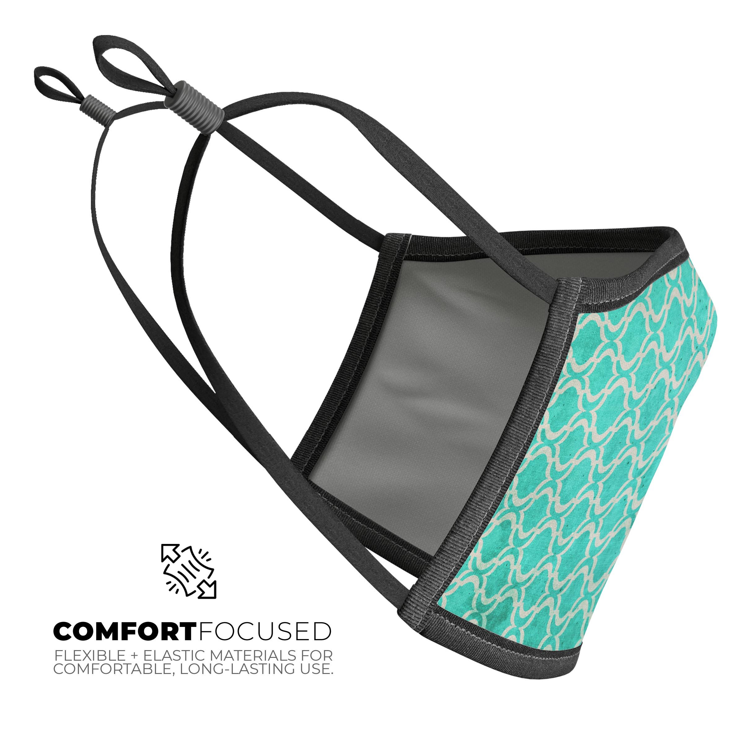 Teal and white bubble Moroccan pattern reusable face mask, showcasing adjustable ear-loops and soft cotton interior.