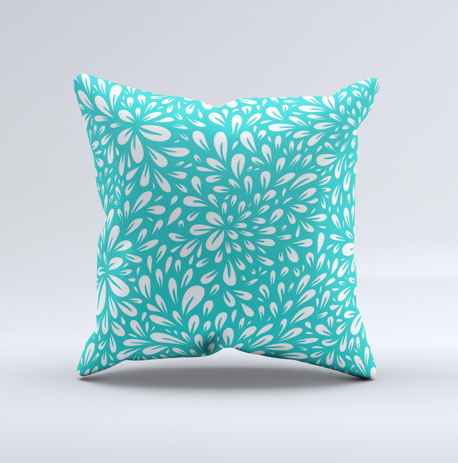 Teal and white floral decorative throw pillow with intricate ink-fuzed design, showcasing a handcrafted quality and unique imperfections.