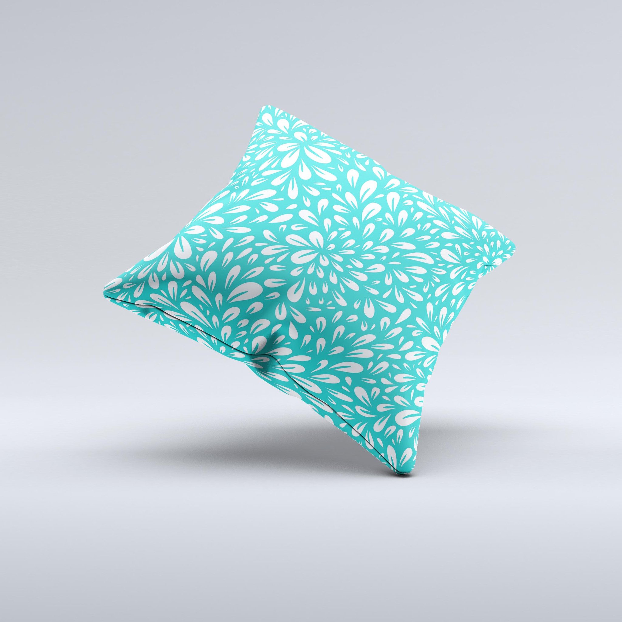 Teal and white floral decorative throw pillow with intricate ink-fuzed design, showcasing a handcrafted quality and unique imperfections.