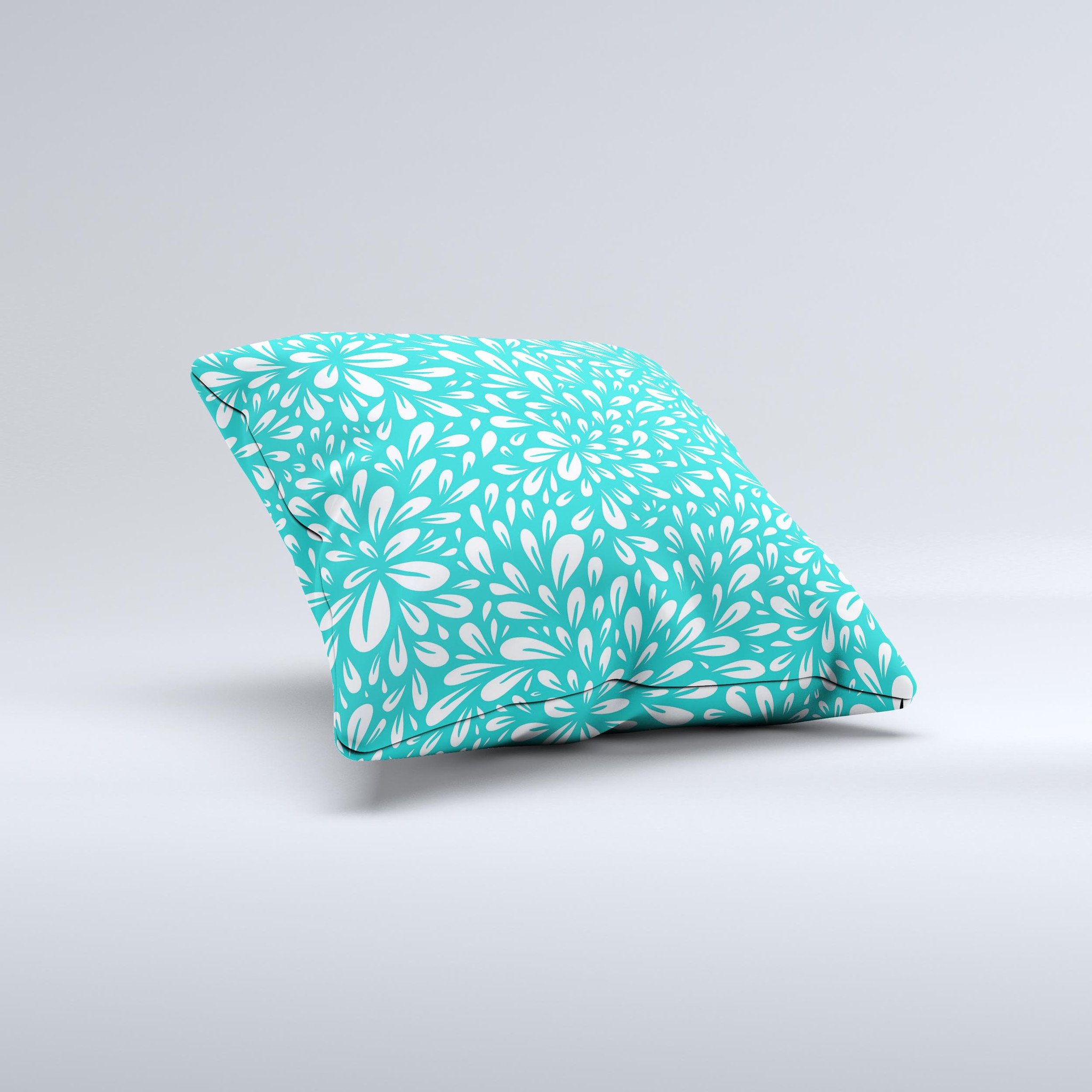 Teal and white floral decorative throw pillow with intricate ink-fuzed design, showcasing a handcrafted quality and unique imperfections.