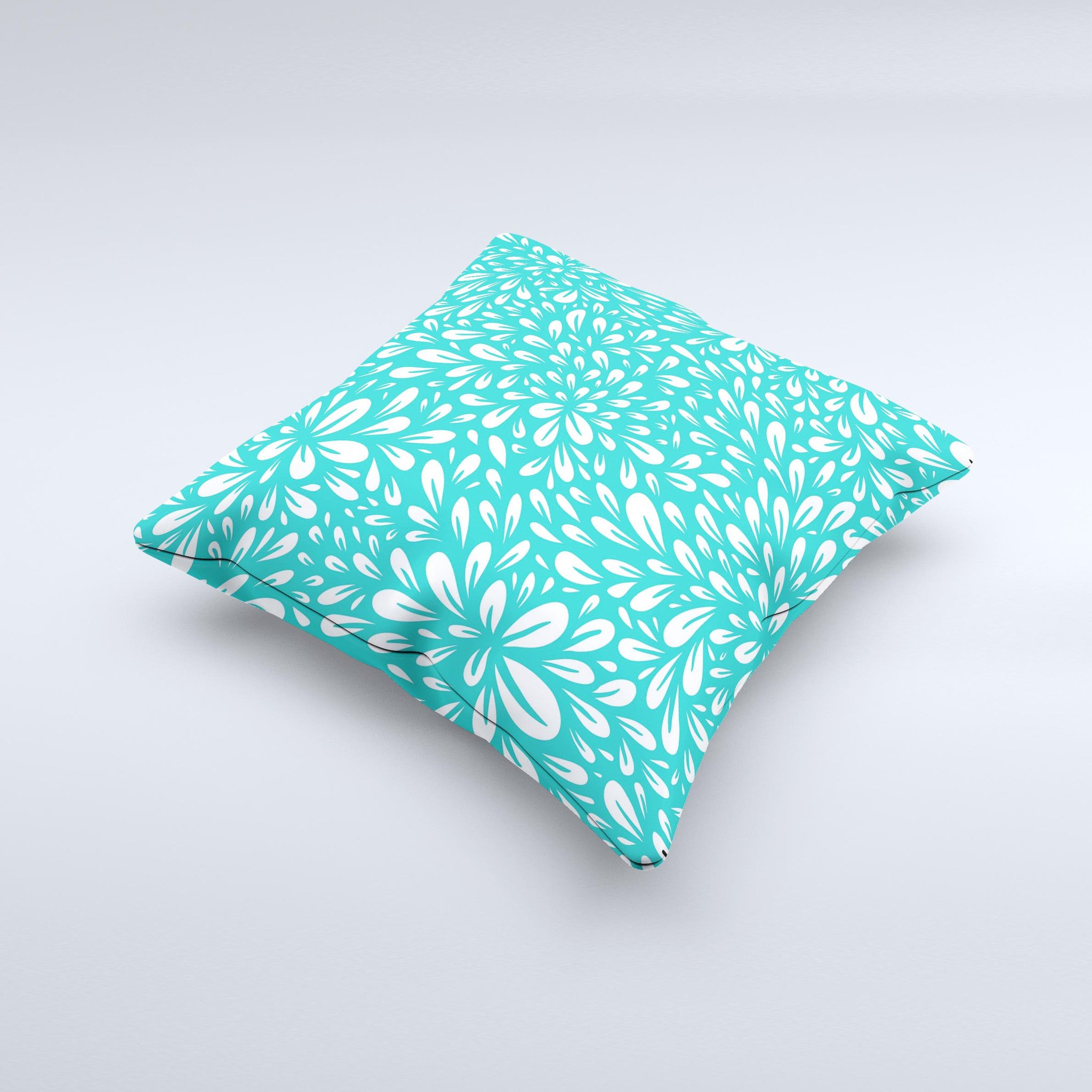 Teal and white floral decorative throw pillow with intricate ink-fuzed design, showcasing a handcrafted quality and unique imperfections.