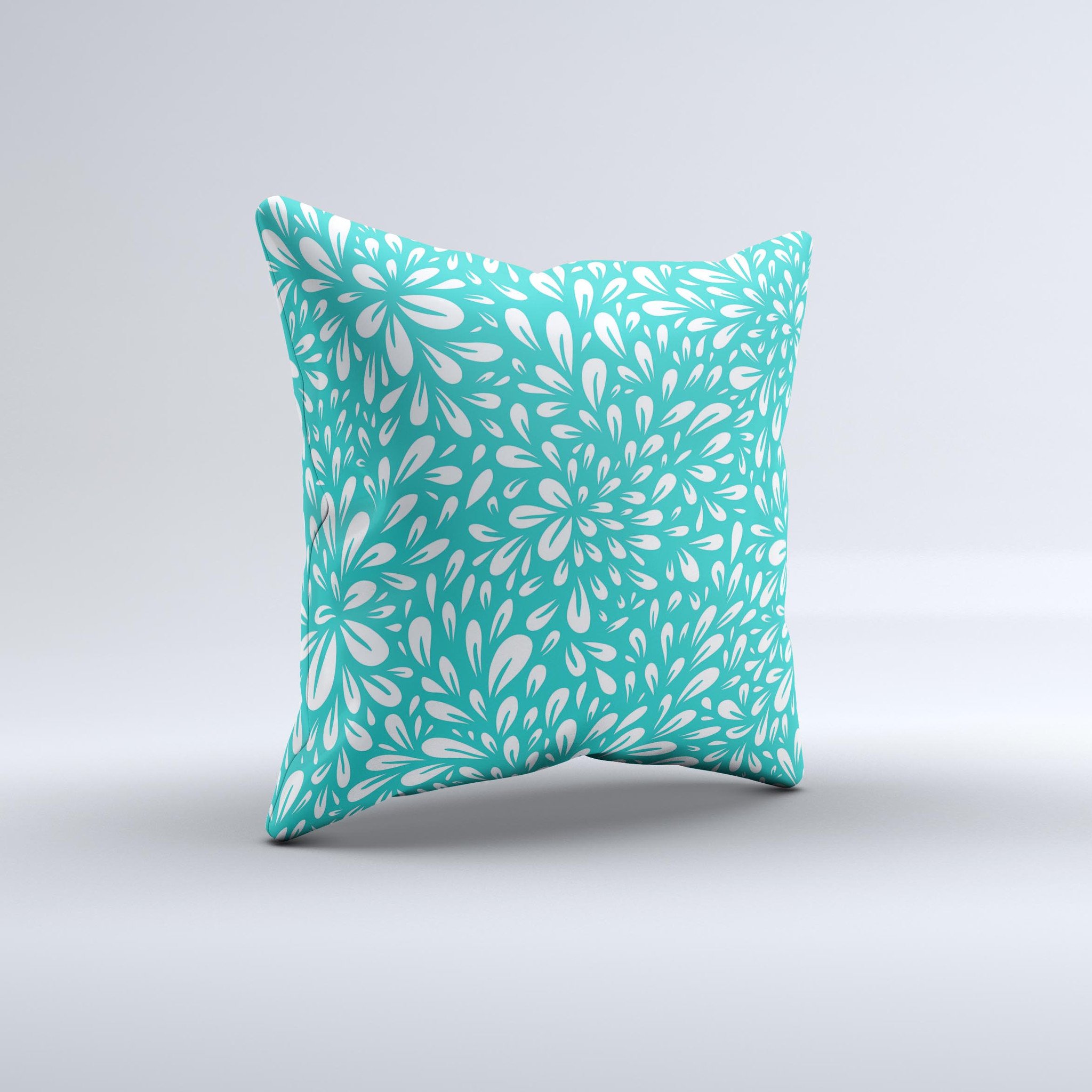 Teal and white floral decorative throw pillow with intricate ink-fuzed design, showcasing a handcrafted quality and unique imperfections.