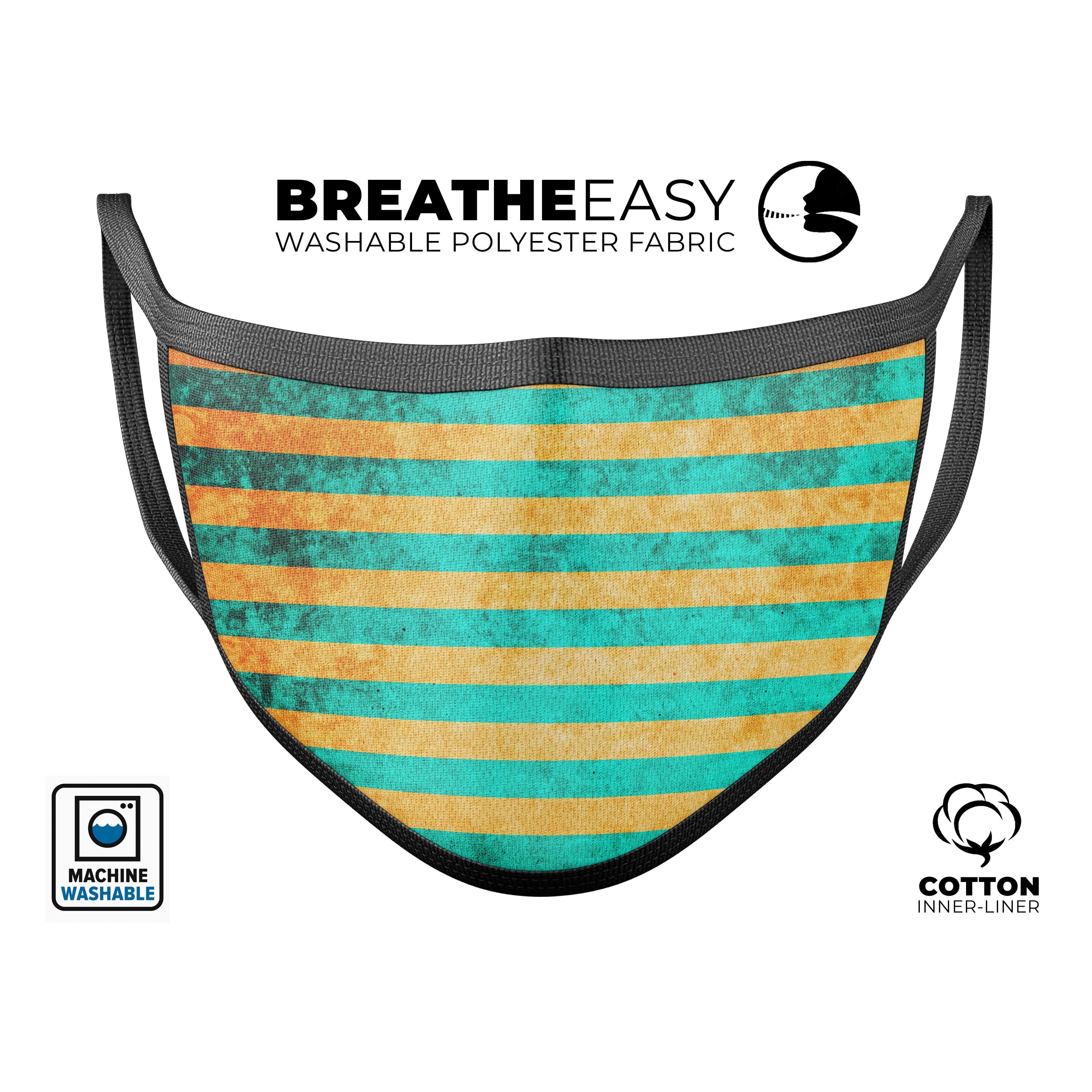 Teal green face mask with vertical gold stripes, showcasing adjustable ear loops and soft cotton interior.