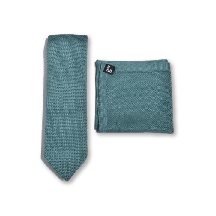 Teal knitted tie and pocket square set displayed elegantly, showcasing the vibrant color and texture.