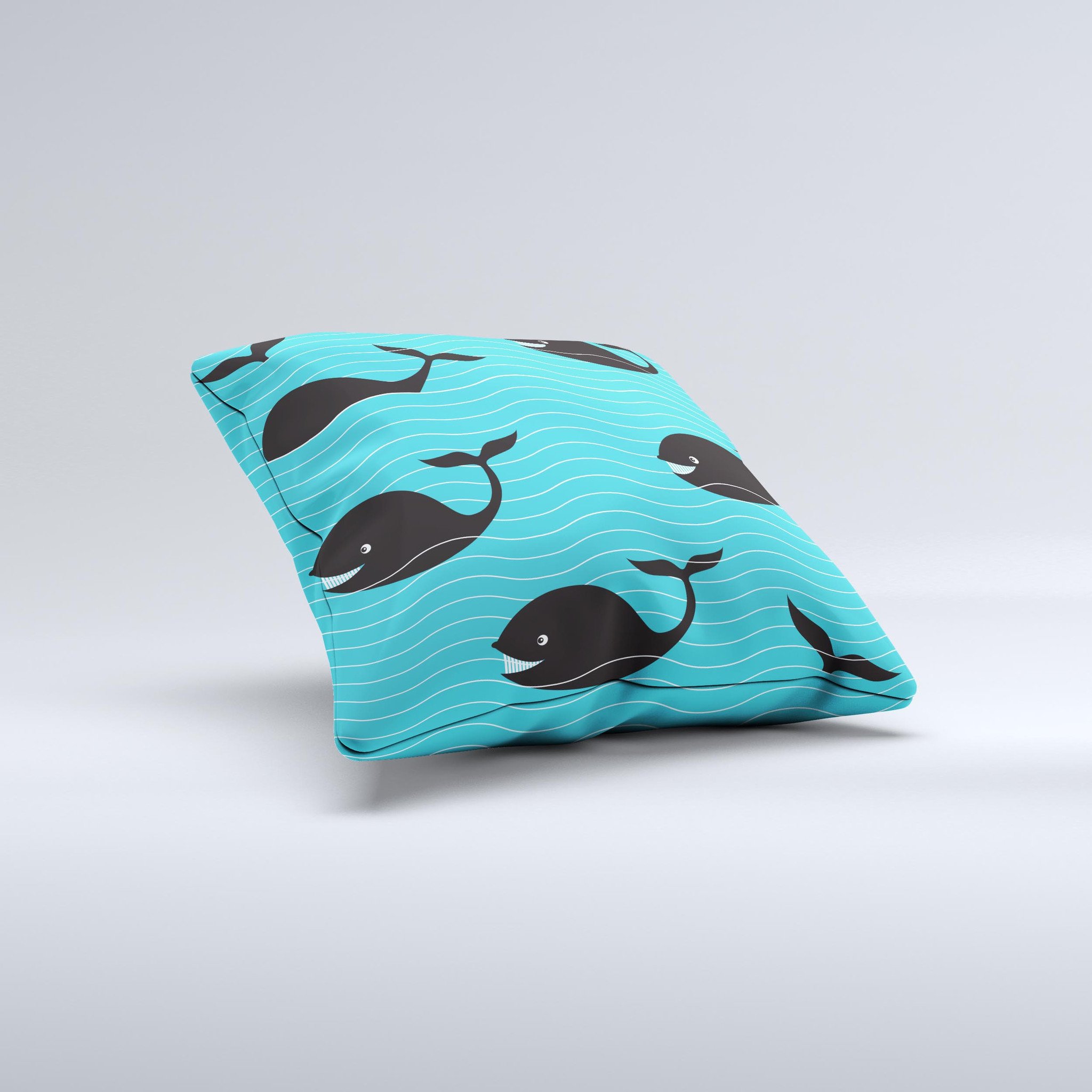 Teal decorative throw pillow featuring a smiling black whale pattern, showcasing vibrant colors and a unique handmade design.