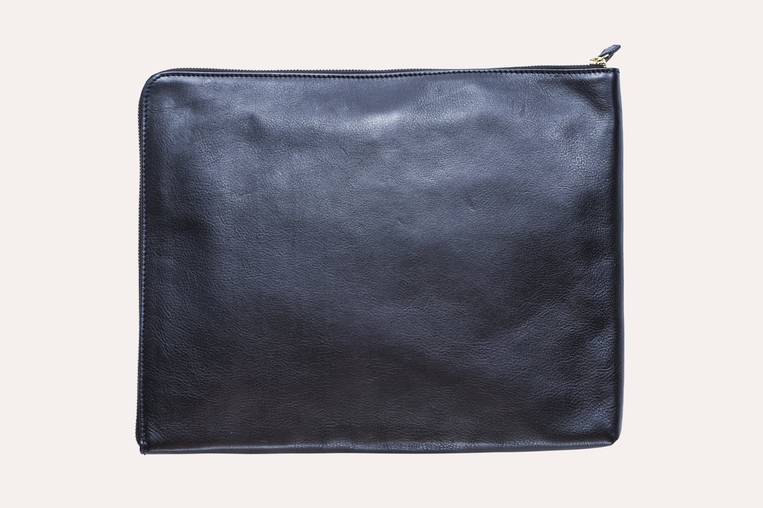 Tech-Folio genuine leather laptop sleeve with zipper closure and internal pocket, designed for 13-inch laptops.