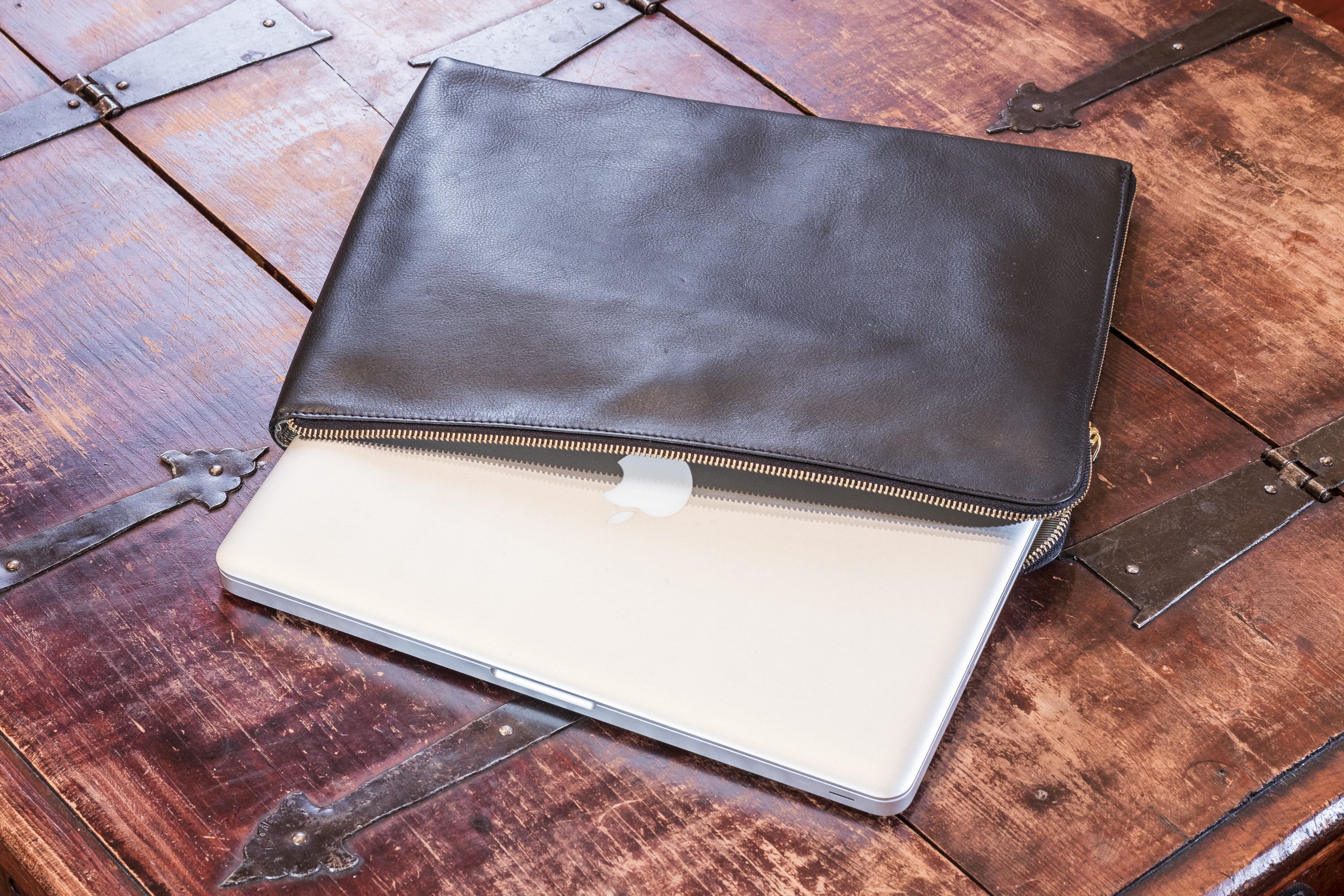 Tech-Folio genuine leather laptop sleeve with zipper closure and internal pocket, designed for 13-inch laptops.