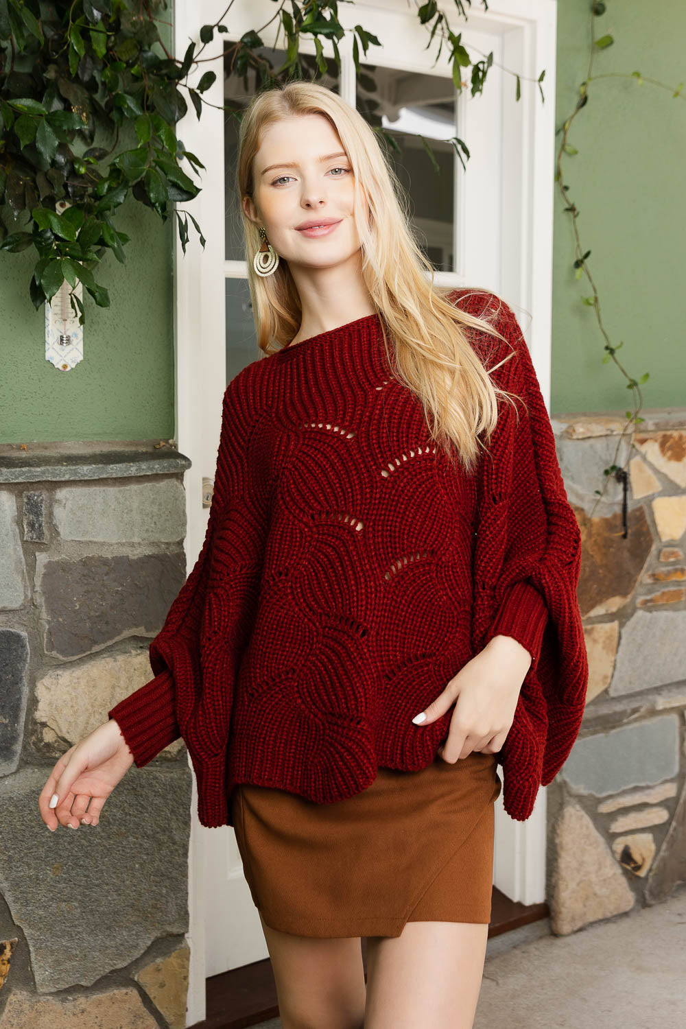 A stylish Texture Trend Sleeve-Knit Poncho featuring a chic ribbed knit design with convenient sleeves, perfect for layering.