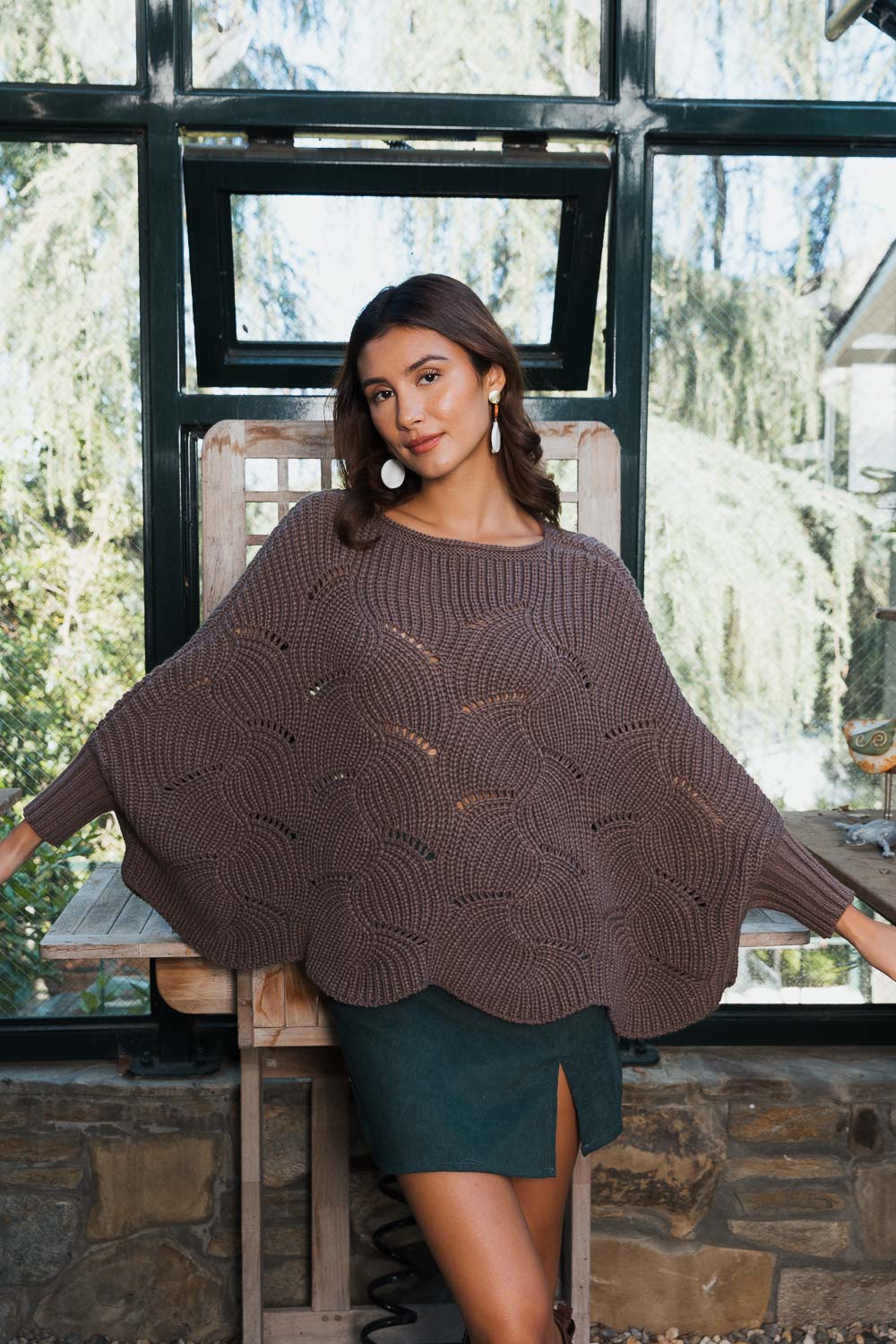 A stylish Texture Trend Sleeve-Knit Poncho featuring a chic ribbed knit design with convenient sleeves, perfect for layering.