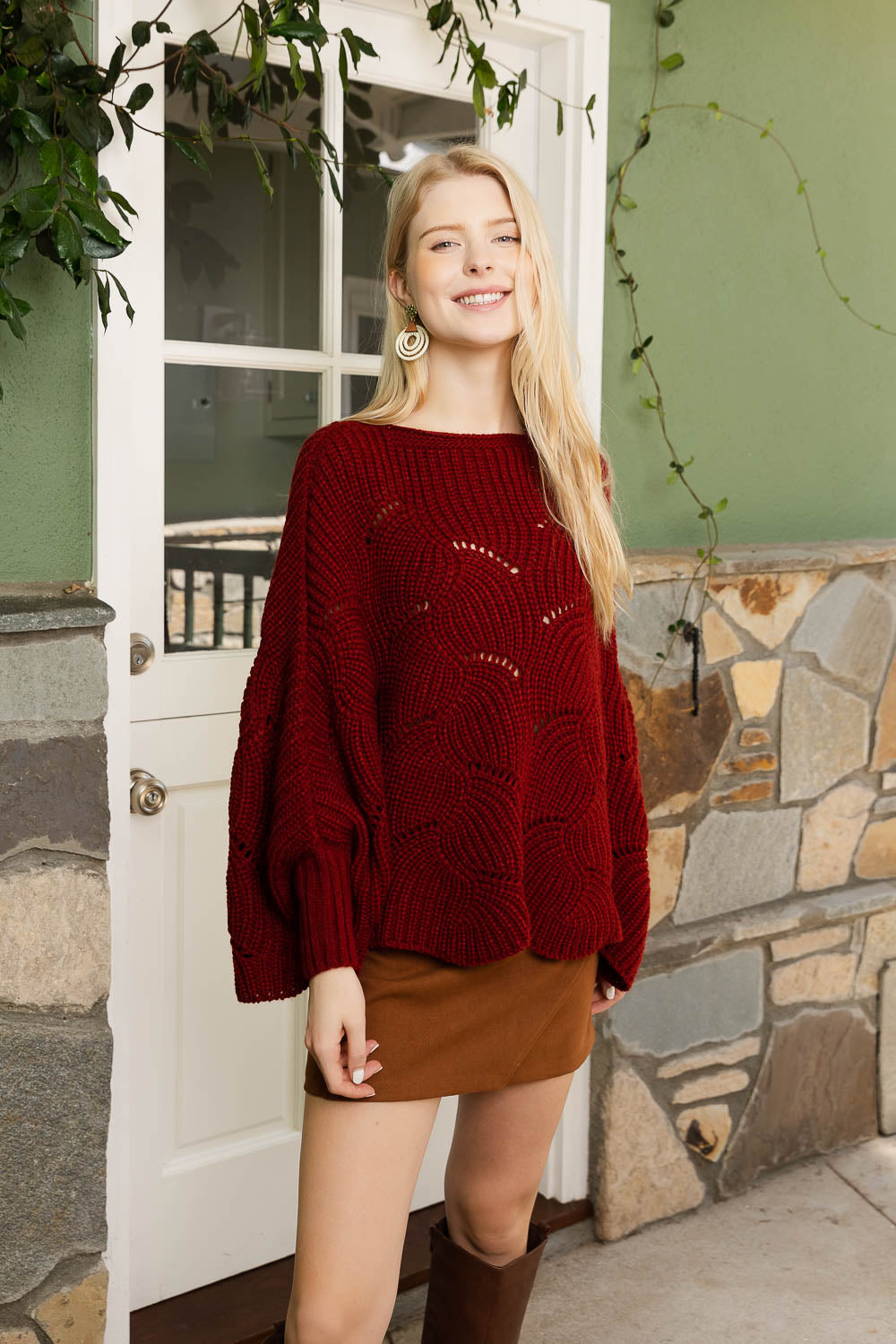 A stylish Texture Trend Sleeve-Knit Poncho featuring a chic ribbed knit design with convenient sleeves, perfect for layering.