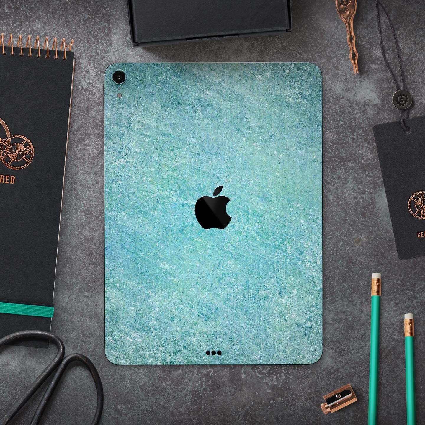 Textured teal surface skin decal for Apple iPad Pro, showcasing its premium quality and design.