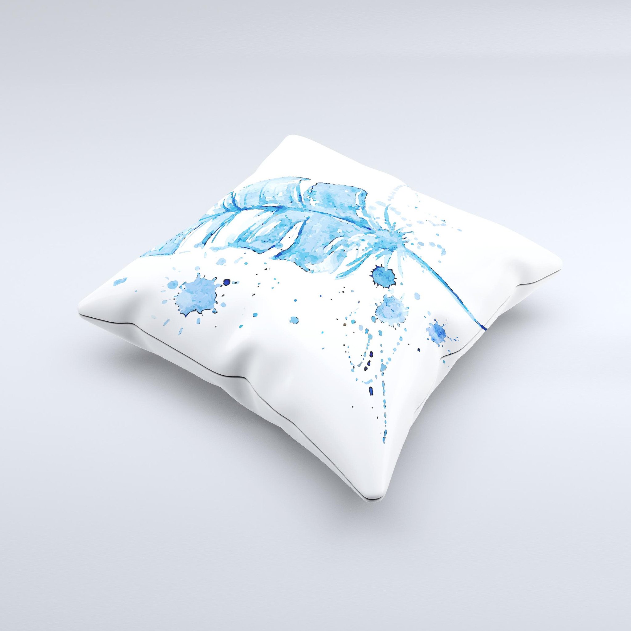 A vibrant Blue Splatter Feather ink-Fuzed Decorative Throw Pillow showcasing unique hand-produced graphics and high-quality fabric.