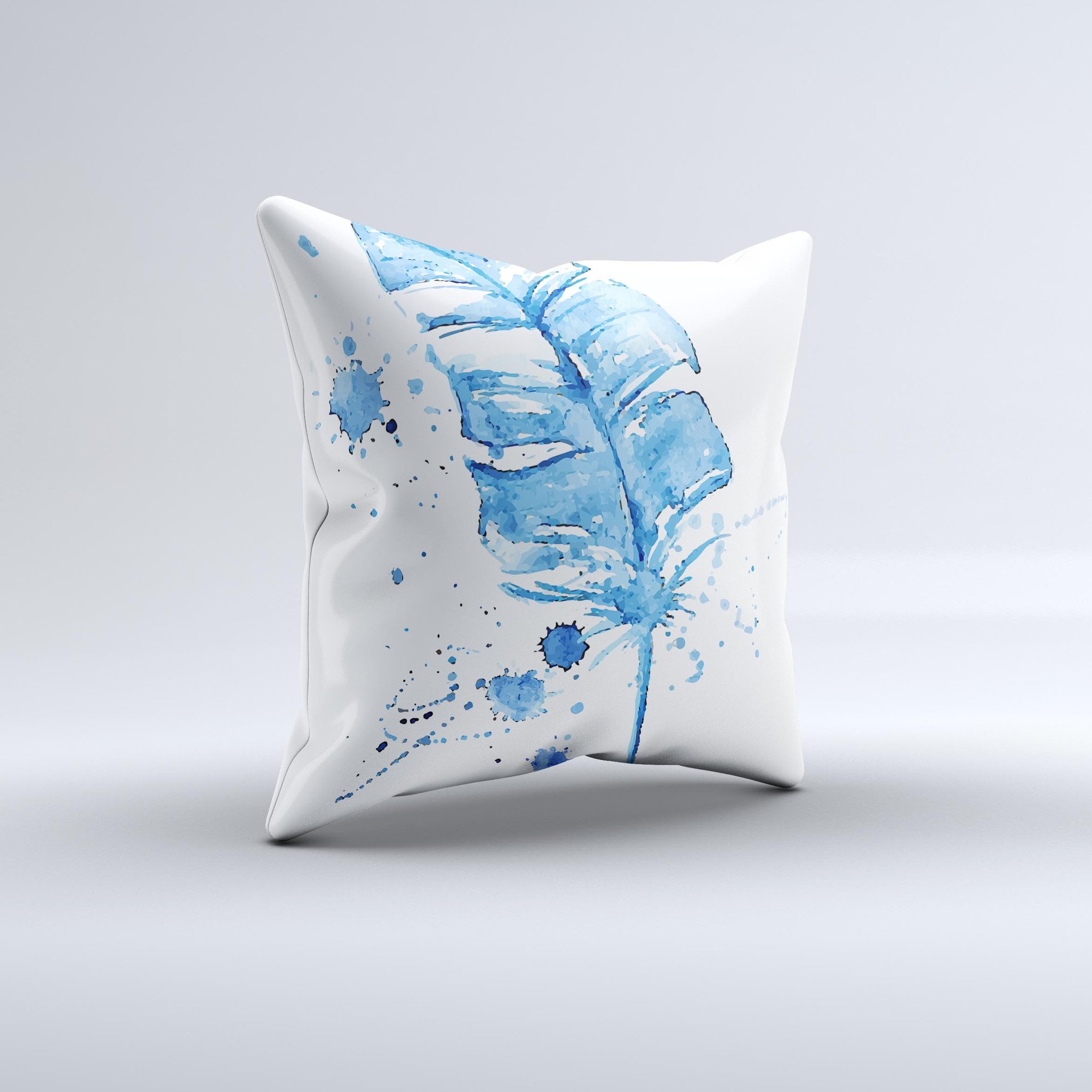 A vibrant Blue Splatter Feather ink-Fuzed Decorative Throw Pillow showcasing unique hand-produced graphics and high-quality fabric.