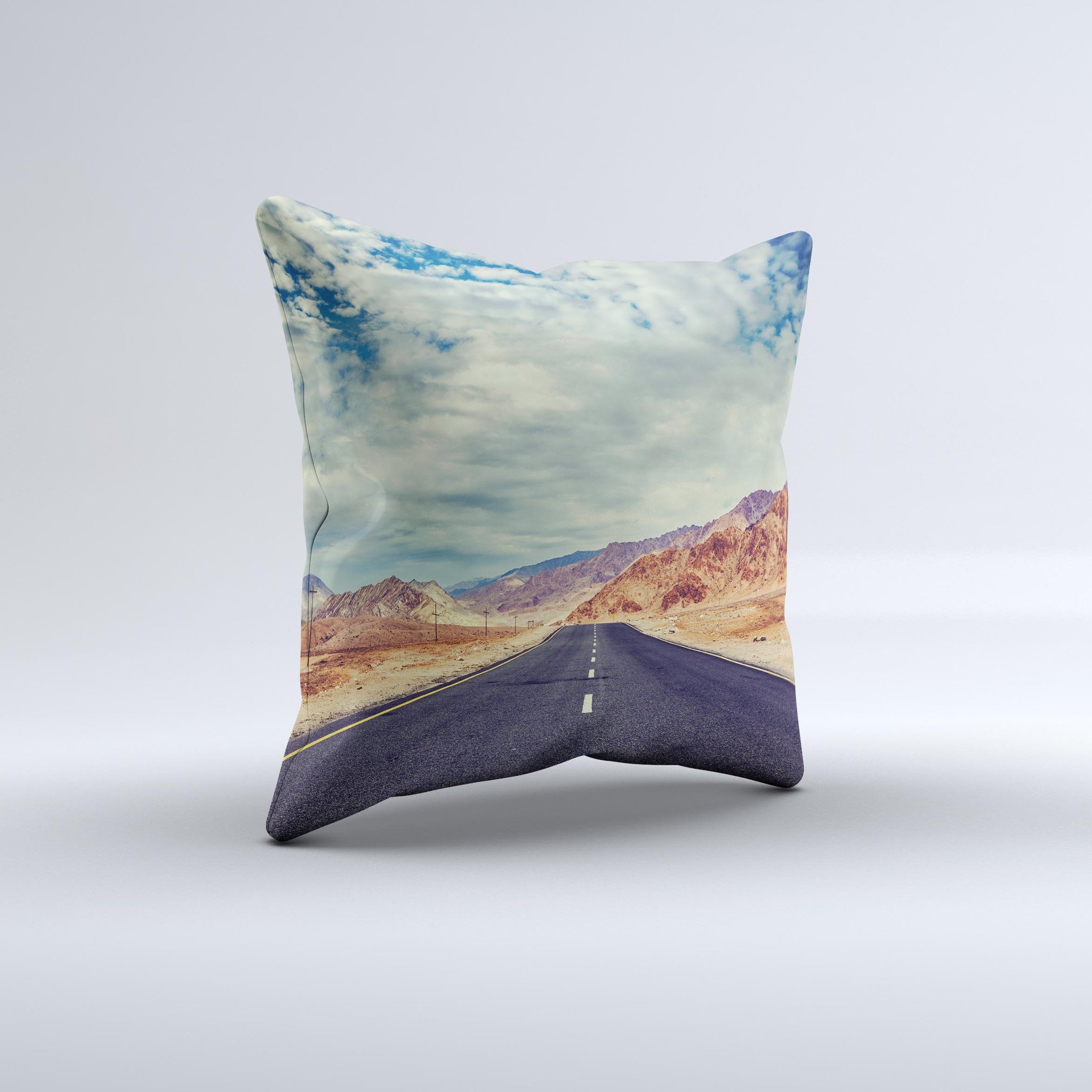 The Desert Road ink-Fuzed Decorative Throw Pillow featuring a unique handcrafted design with high thread count fabric and vibrant colors.