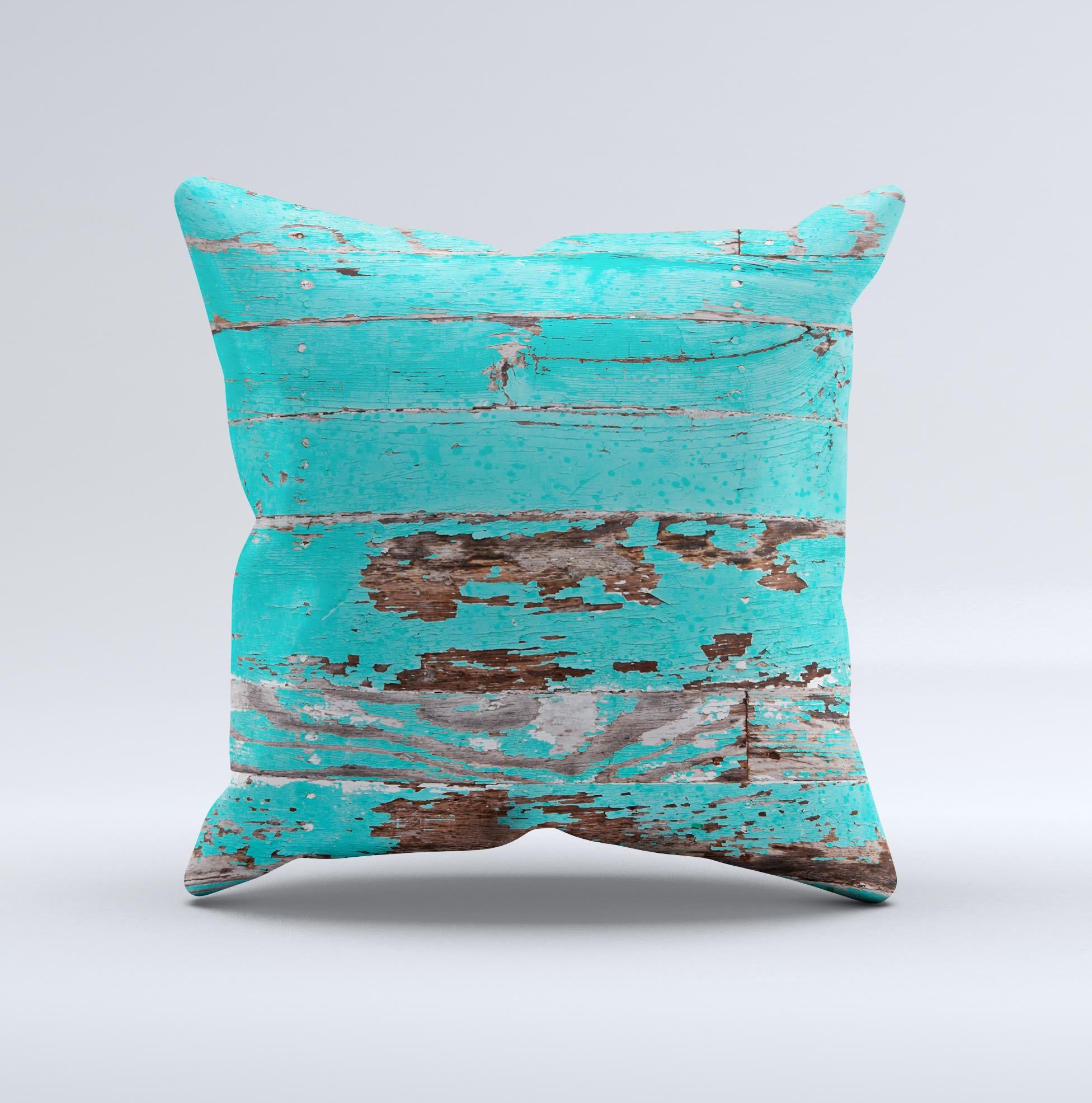 Turquoise decorative throw pillow with chipped paint design, handcrafted in Virginia, showcasing unique imperfections.