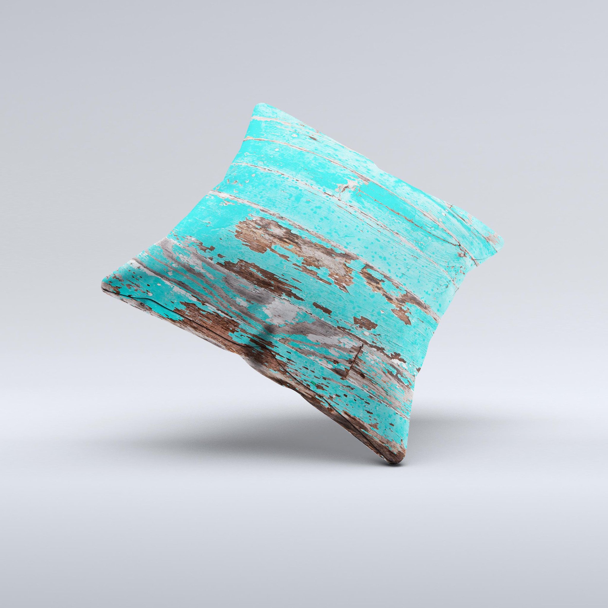 Turquoise decorative throw pillow with chipped paint design, handcrafted in Virginia, showcasing unique imperfections.