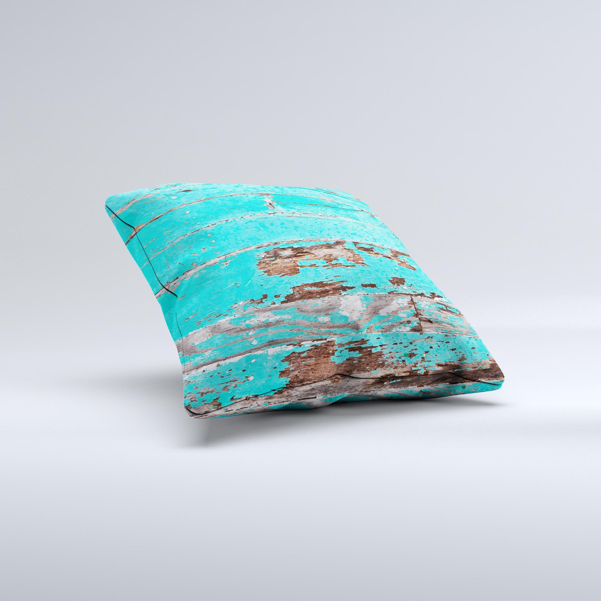 Turquoise decorative throw pillow with chipped paint design, handcrafted in Virginia, showcasing unique imperfections.