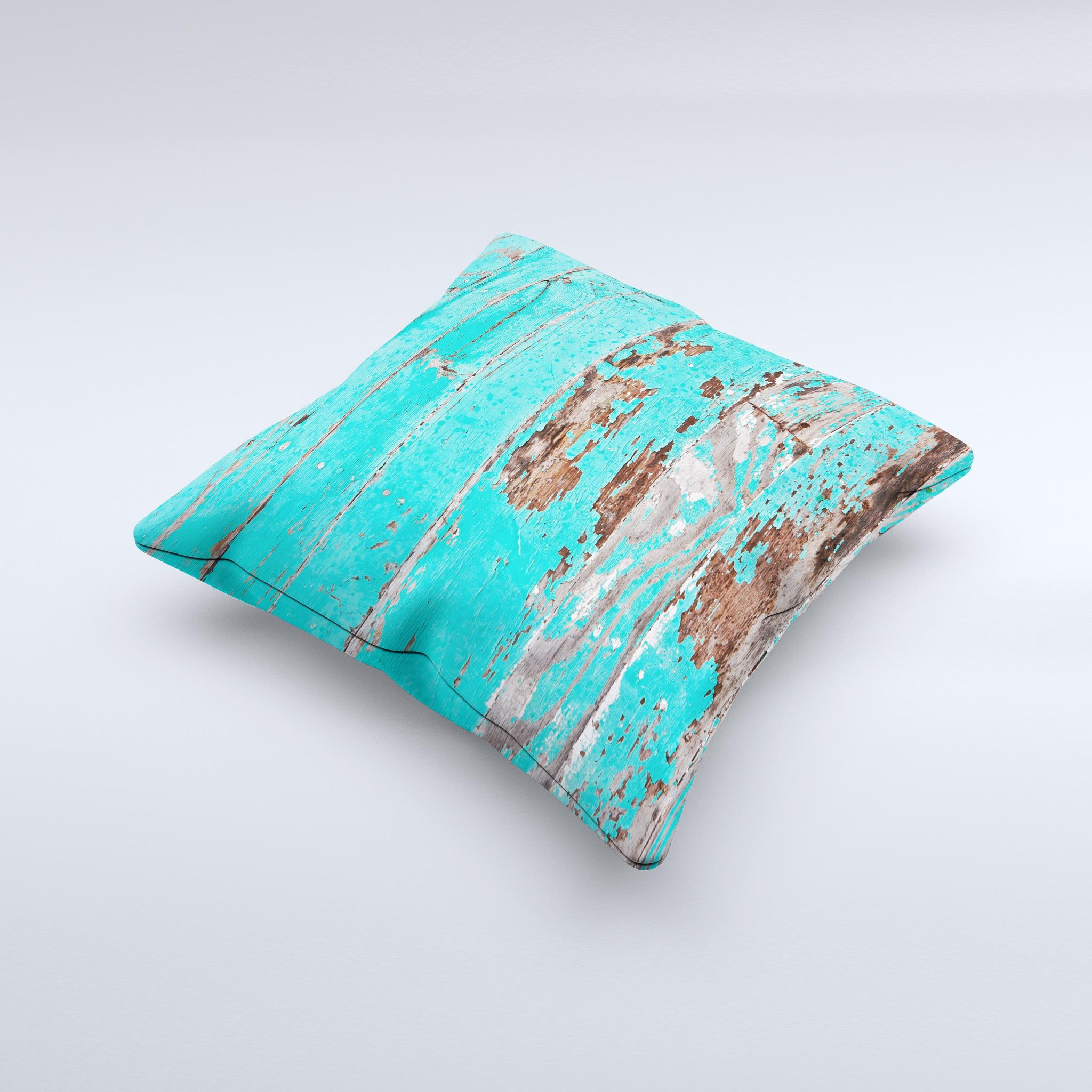 Turquoise decorative throw pillow with chipped paint design, handcrafted in Virginia, showcasing unique imperfections.