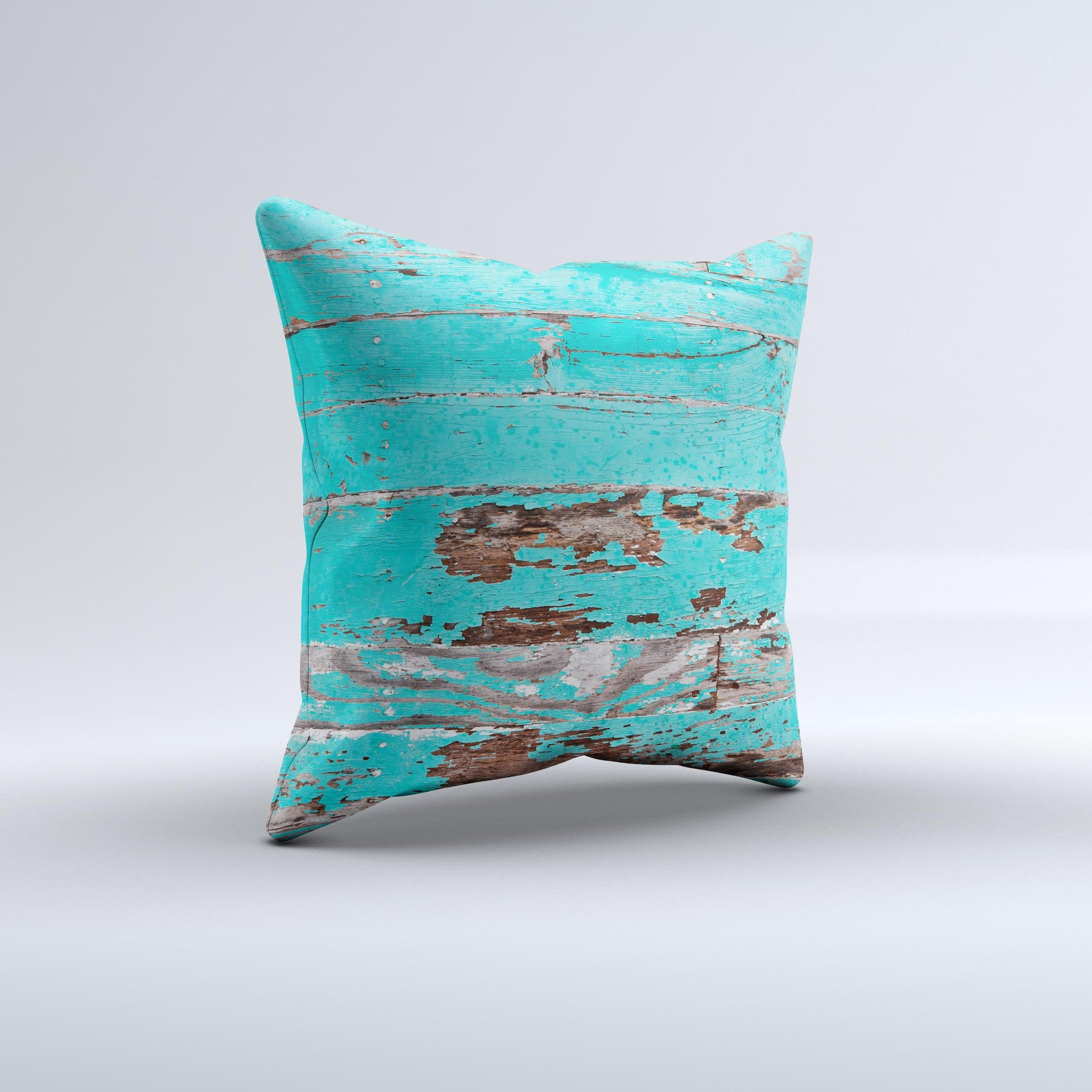 Turquoise decorative throw pillow with chipped paint design, handcrafted in Virginia, showcasing unique imperfections.