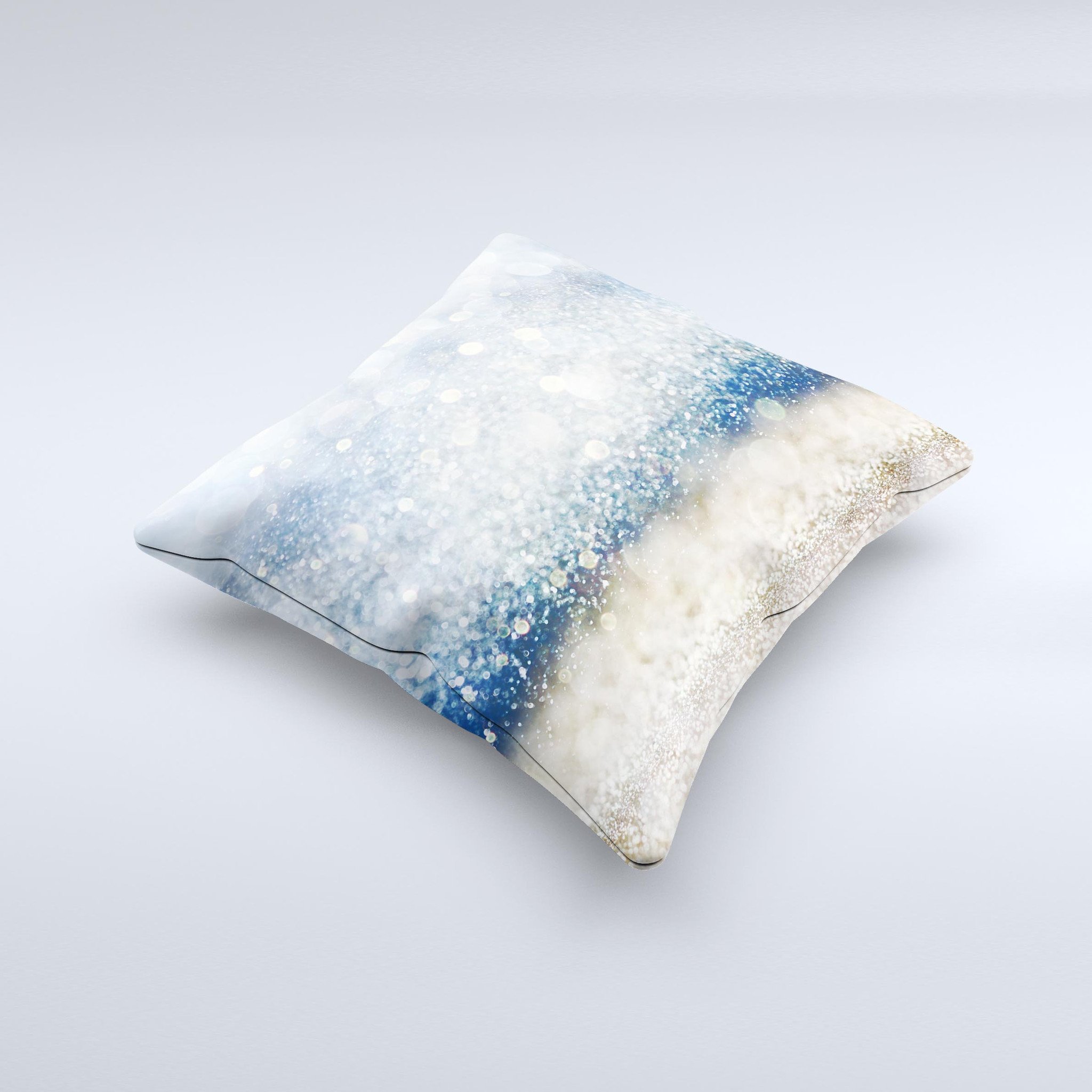 A decorative throw pillow featuring unfocused blue and gold sparkles, showcasing a unique handmade design with a high thread count fabric.