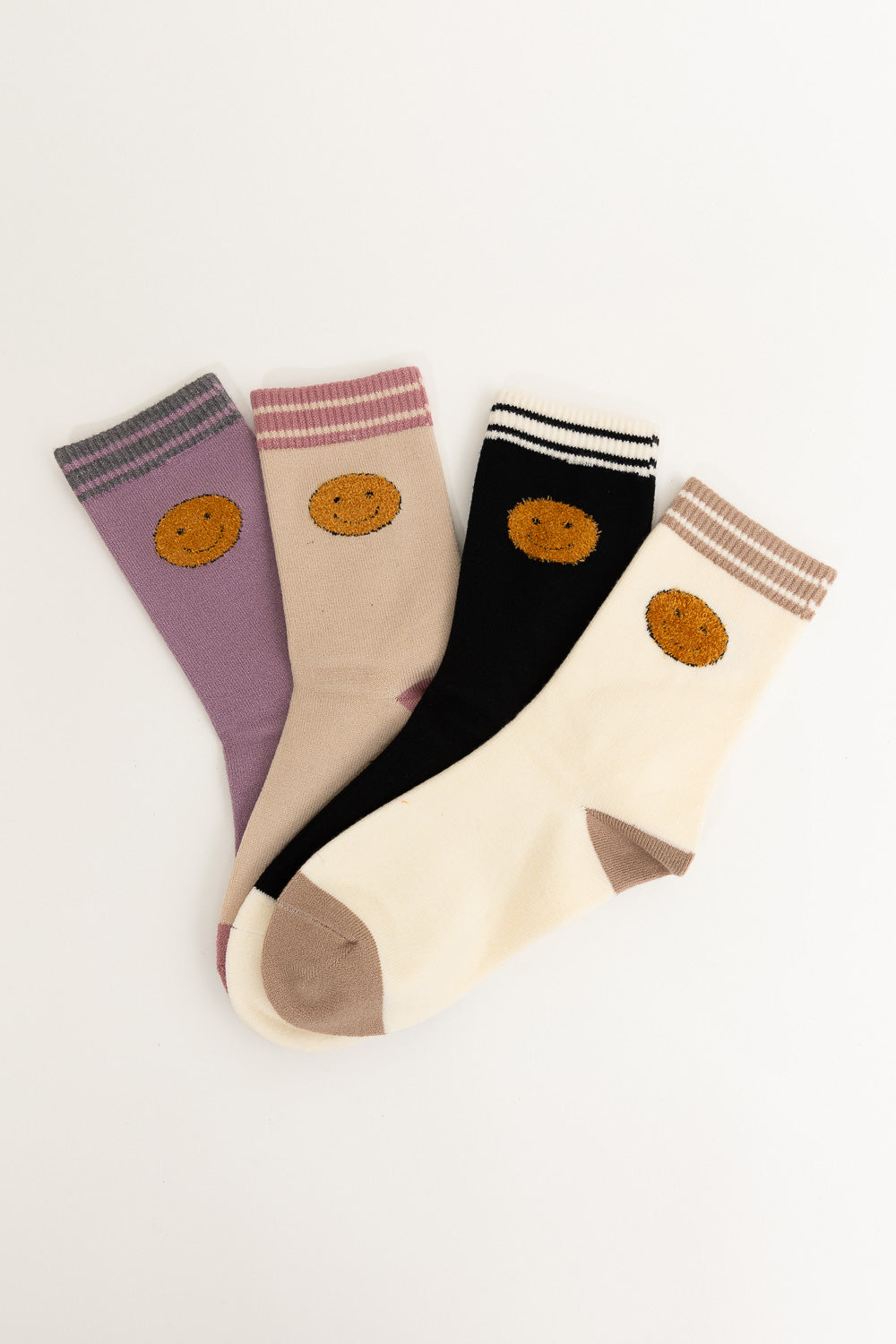 A pair of Threaded Smiles Crew Socks featuring a playful smiley face design, made from soft cashmere for ultimate comfort.