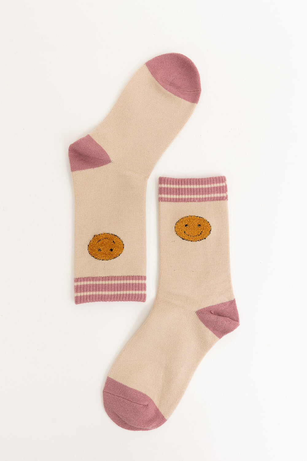 A pair of Threaded Smiles Crew Socks featuring a playful smiley face design, made from soft cashmere for ultimate comfort.