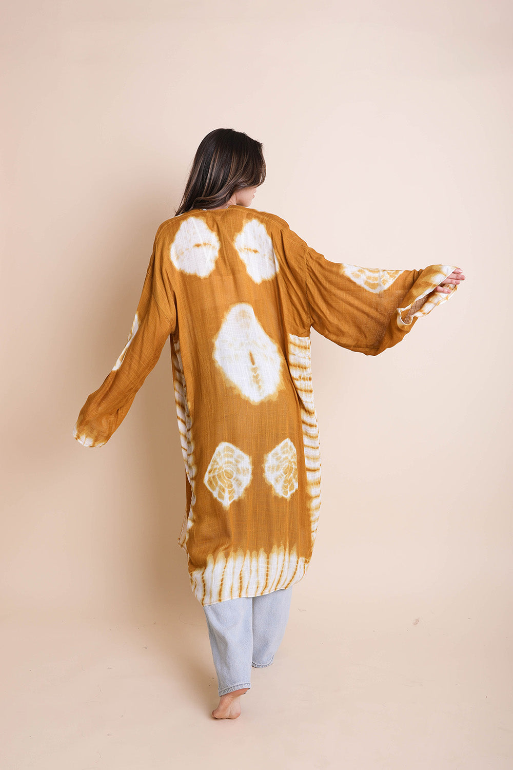 A vibrant Tie Dye Kimono featuring a colorful pattern, perfect for spring and summer wear, made from lightweight polyester fabric.