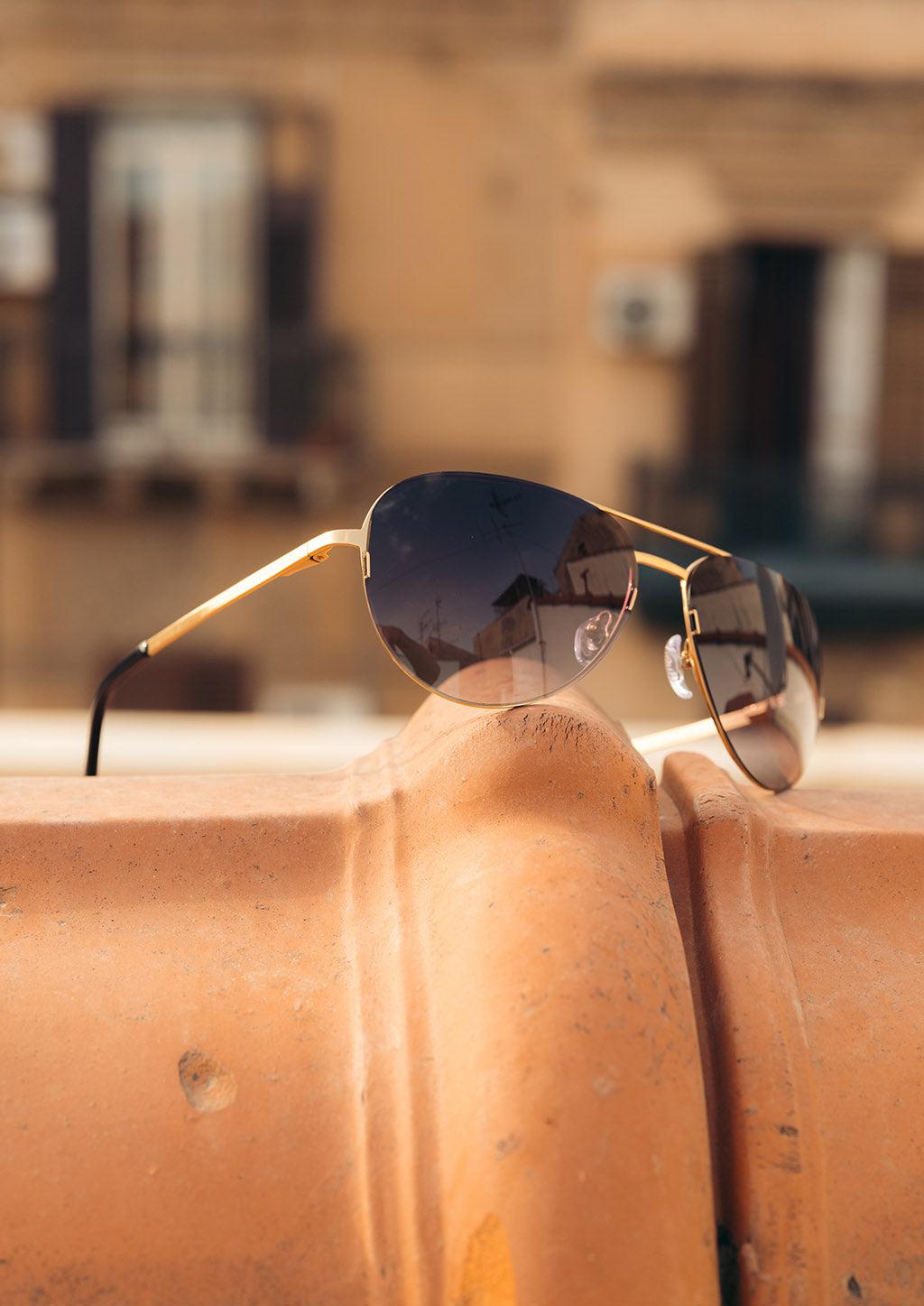 Luxurious Titanium Aviator Sunglasses with 24K gold plating, showcasing a stylish design and polarized lenses for UV protection.