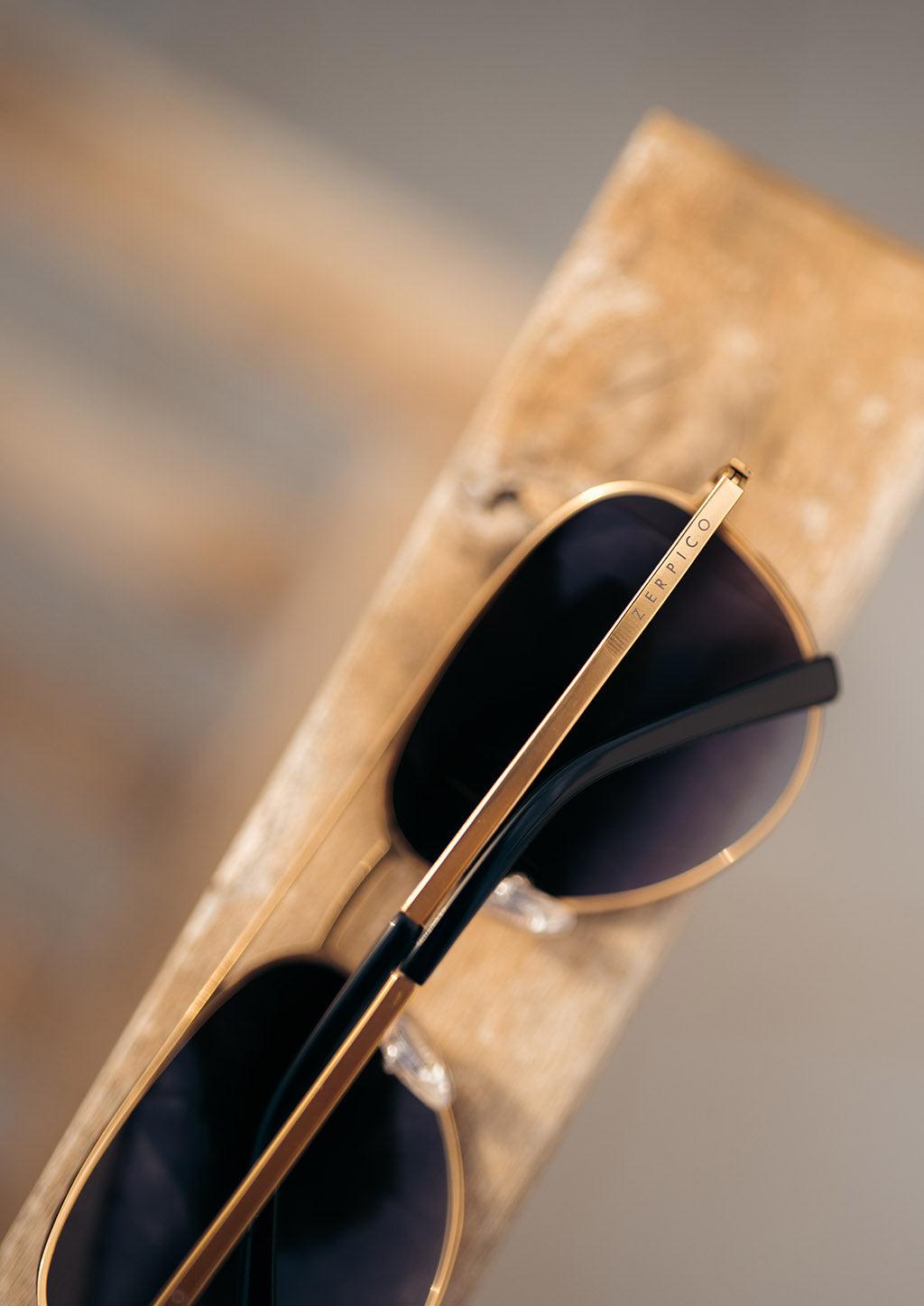 Luxurious Titanium Aviator Sunglasses with 24K gold plating, showcasing a stylish design and polarized lenses for UV protection.