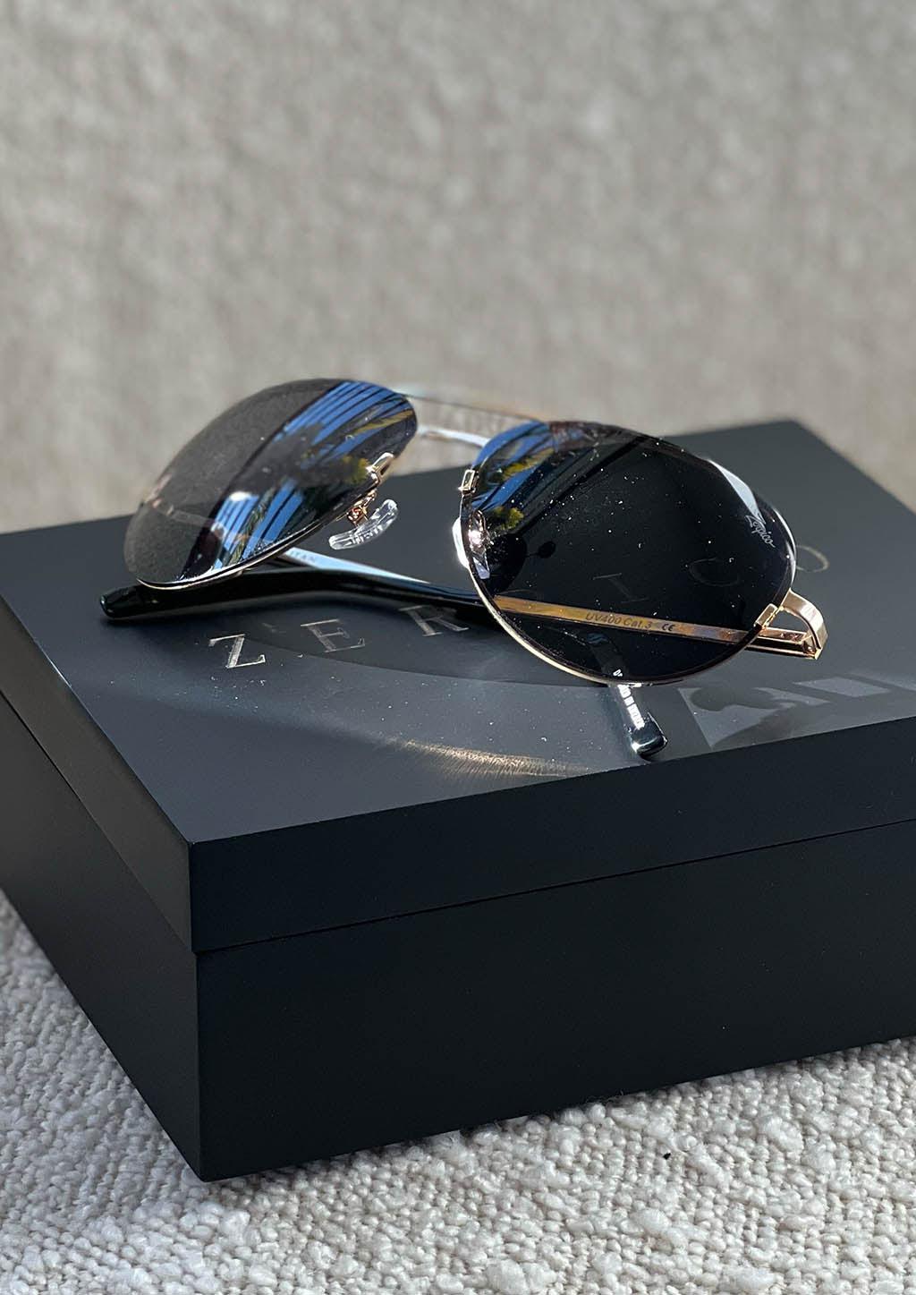 Luxurious Titanium Aviator Sunglasses with 24K gold plating, showcasing a stylish design and polarized lenses for UV protection.