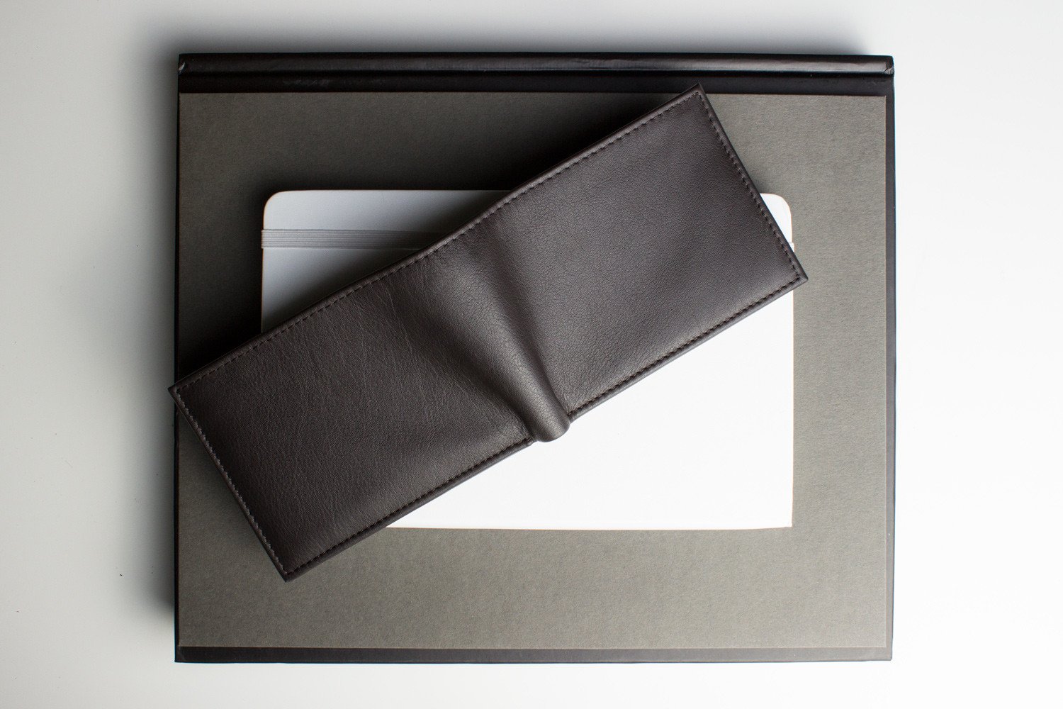 Traditional Bifold Wallet made of glove tanned cowhide leather with removable ID window and multiple card slots.