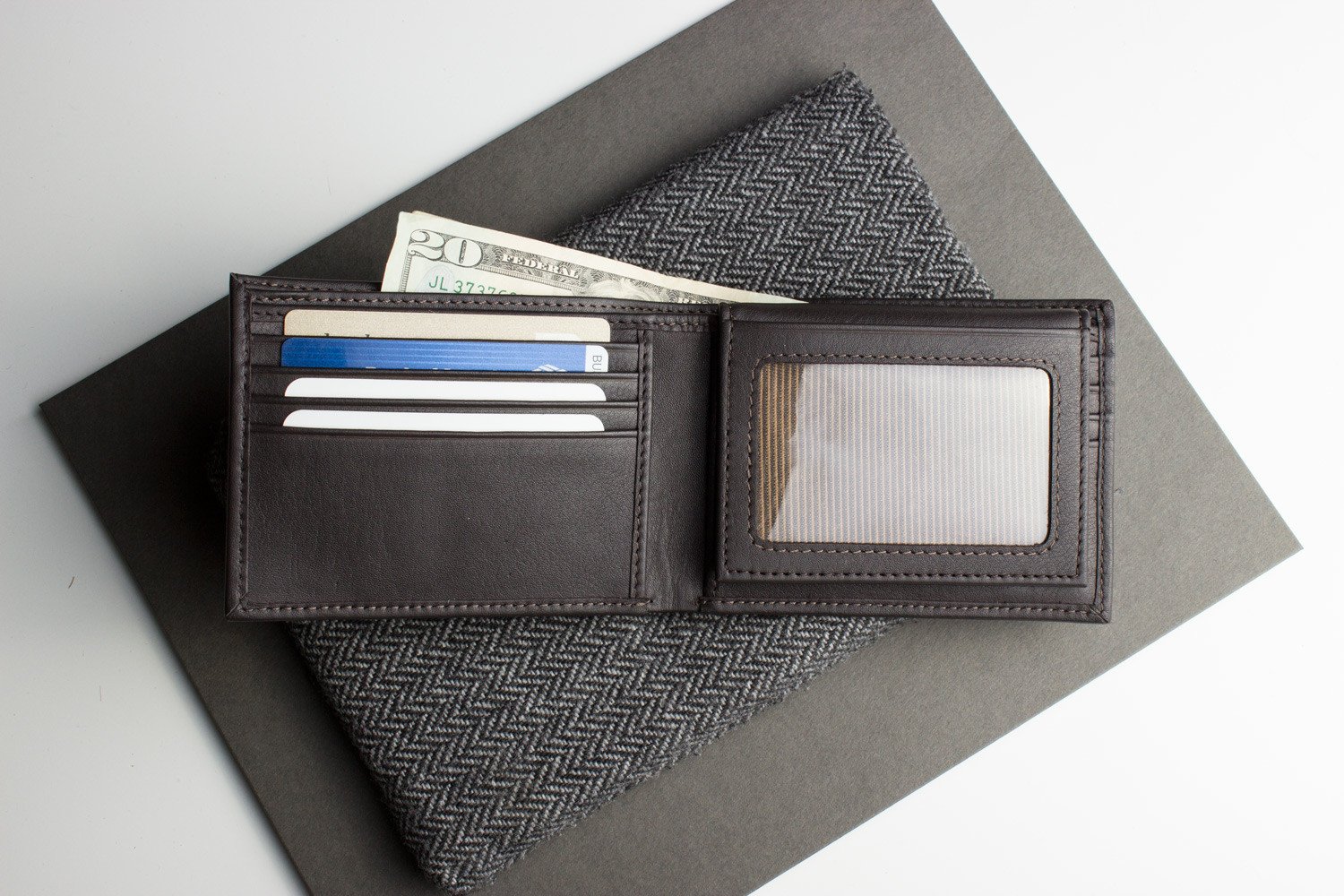 Traditional Bifold Wallet made of glove tanned cowhide leather with removable ID window and multiple card slots.