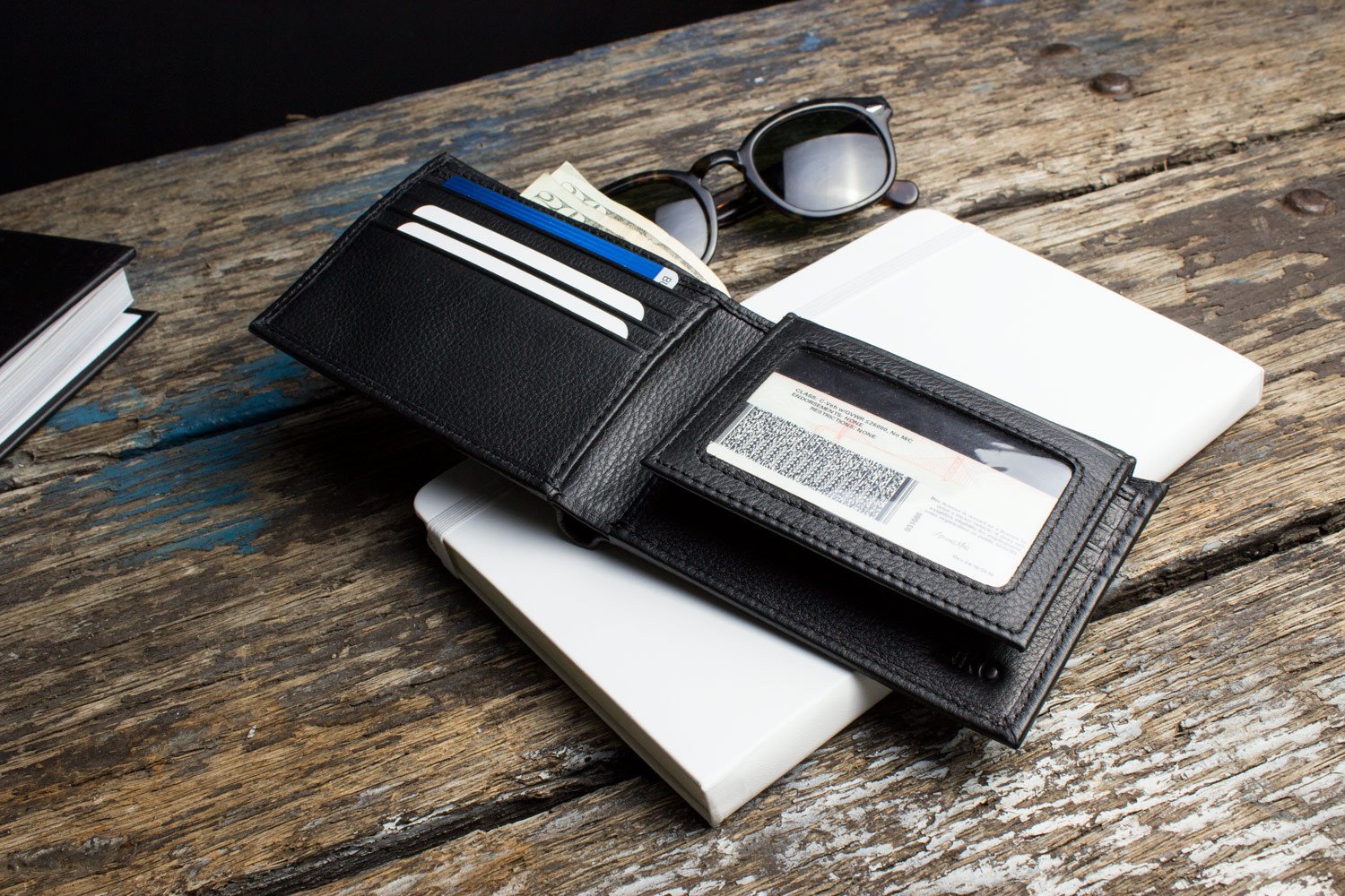 Traditional Bifold Wallet made of glove tanned cowhide leather with removable ID window and multiple card slots.