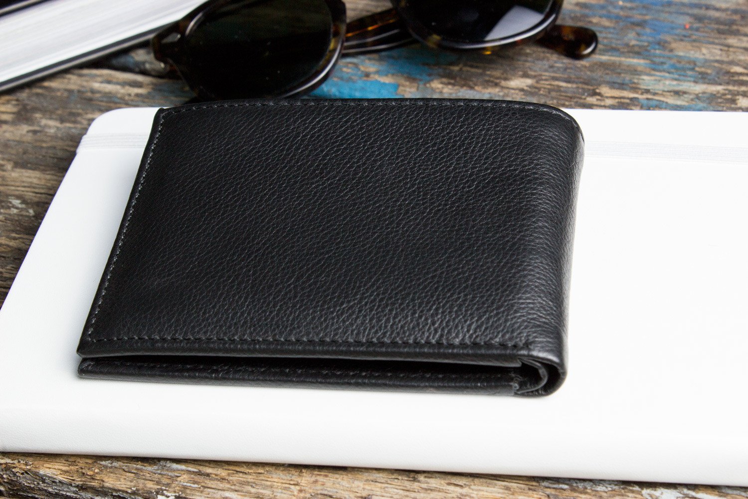 Traditional Bifold Wallet made of glove tanned cowhide leather with removable ID window and multiple card slots.