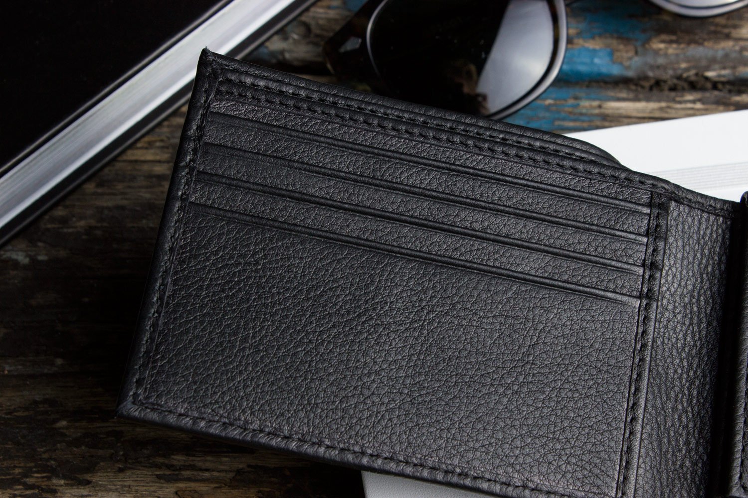 Traditional Bifold Wallet made of glove tanned cowhide leather with removable ID window and multiple card slots.