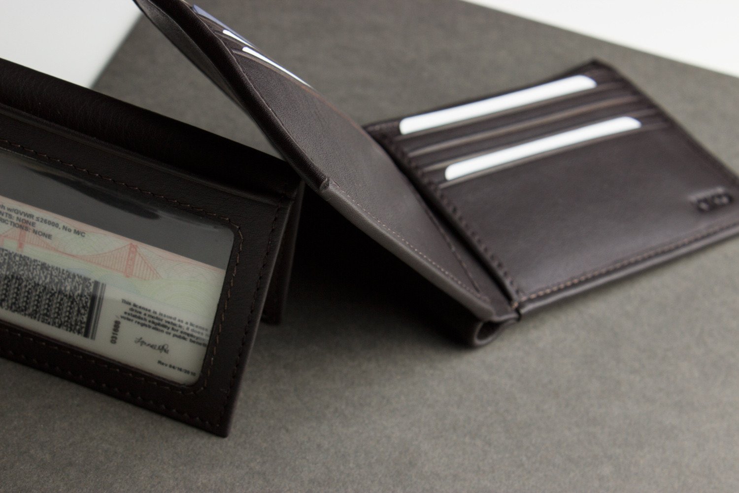 Traditional Bifold Wallet made of glove tanned cowhide leather with removable ID window and multiple card slots.