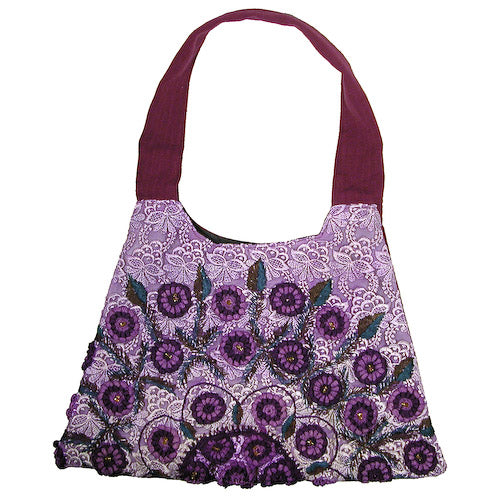 Trapezoid Rococo Handbag made from recycled Huipils, showcasing vibrant colors and unique design, perfect for stylish everyday use.