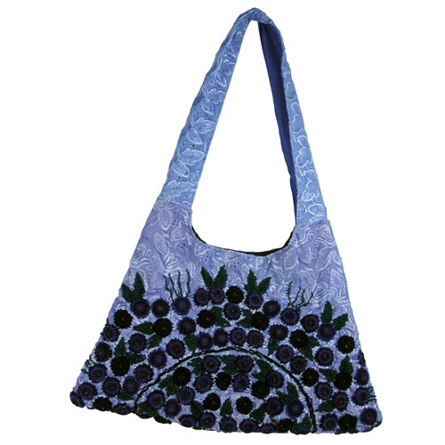 Trapezoid Rococo Handbag made from recycled Huipils, showcasing vibrant colors and unique design, perfect for stylish everyday use.