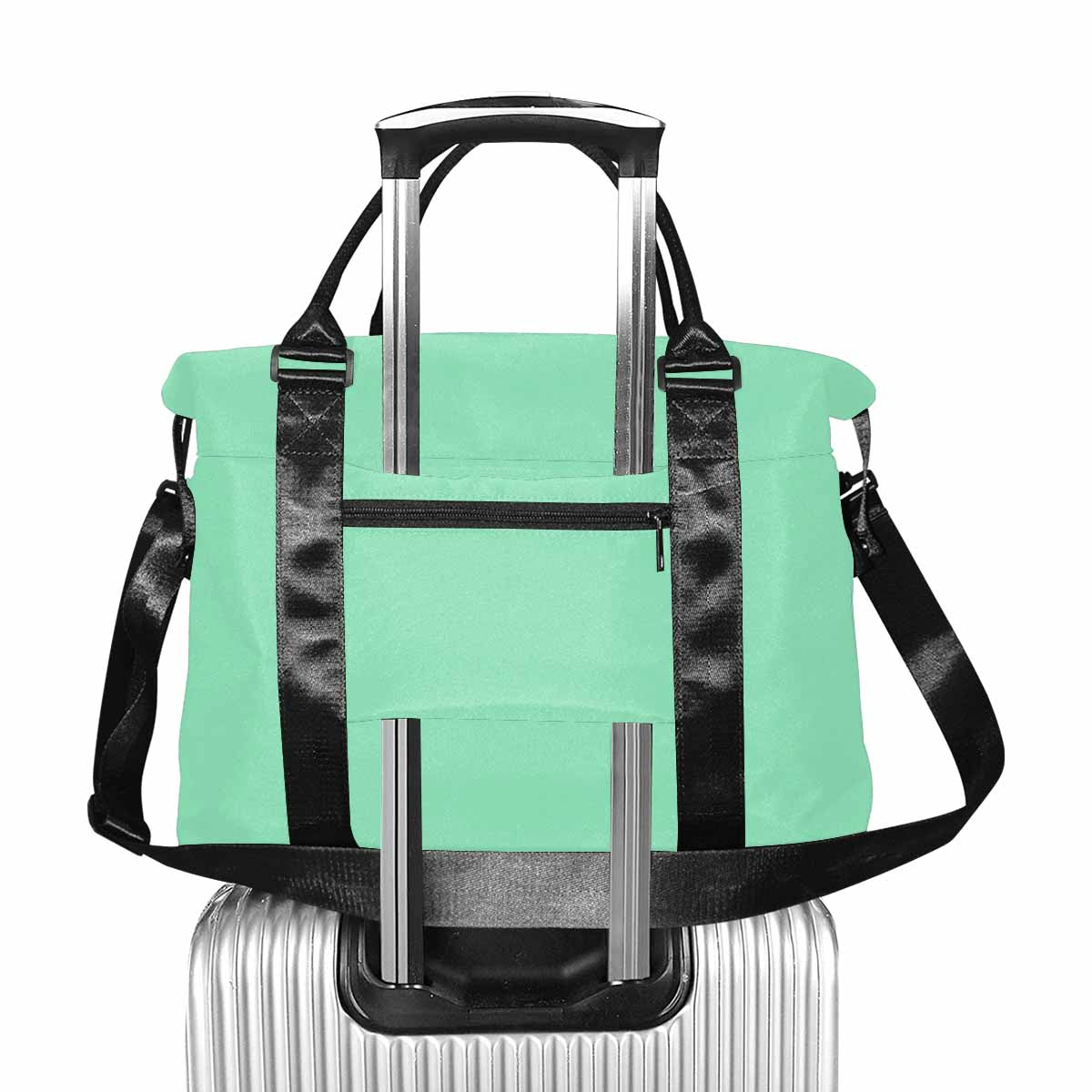 Seafoam green canvas travel bag with metal button closure and adjustable strap, showcasing spacious compartments.